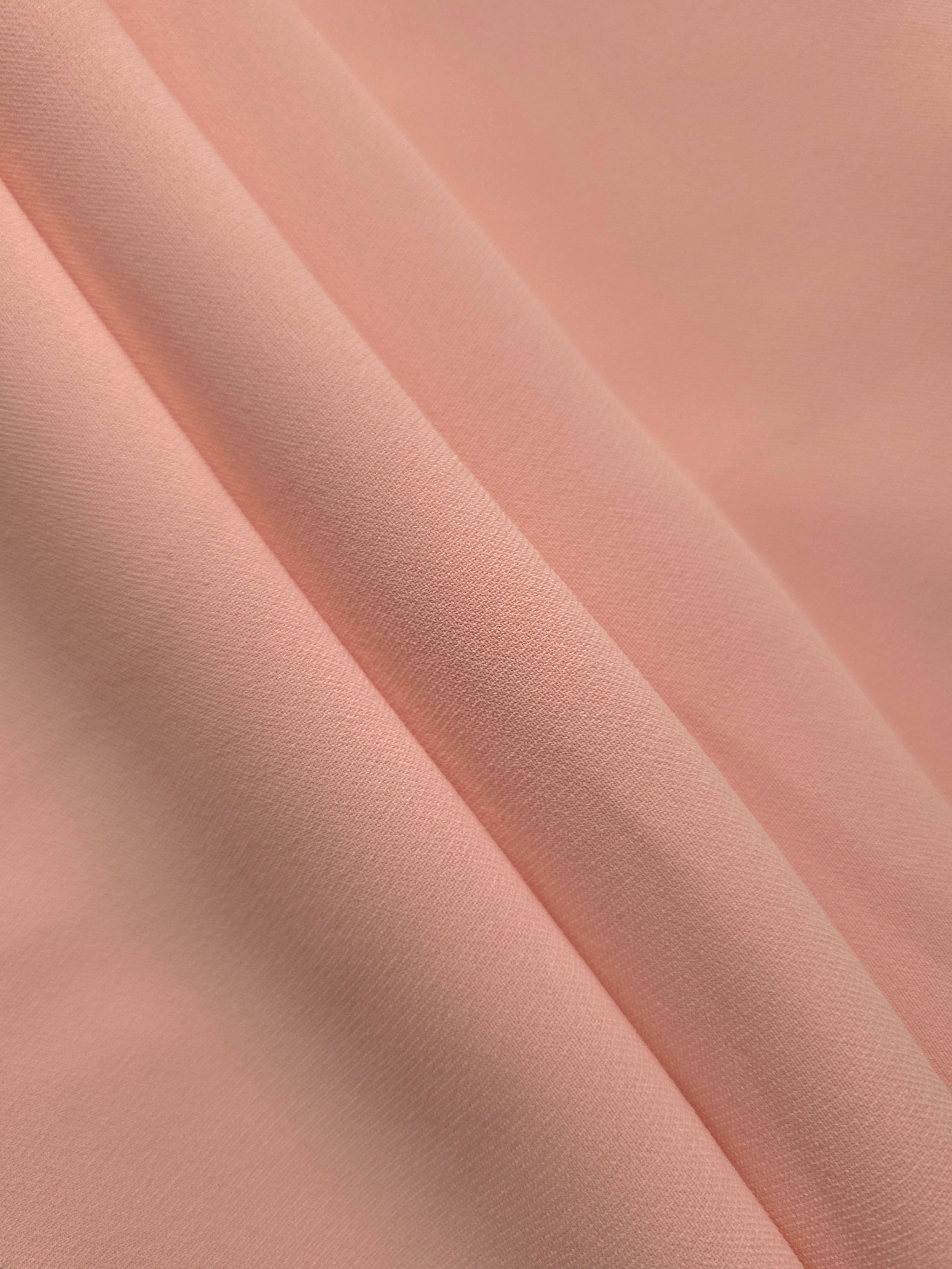 Rose Beige mechanical polyester crepe in layered folds, showing gentle stretch and structure for dressmaking