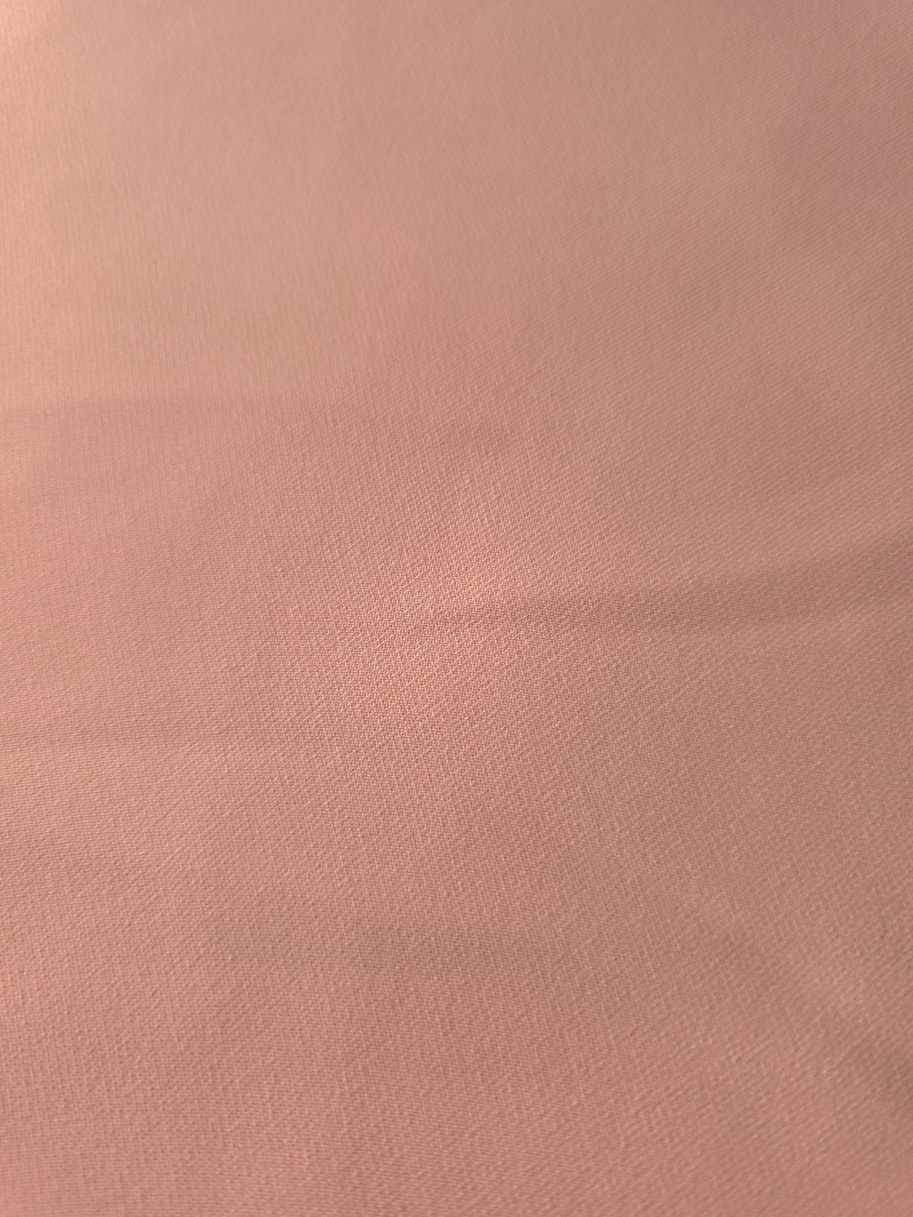 Woven close-up of Rose Beige mechanical polyester crepe showing smooth texture and a soft silky-feel finish