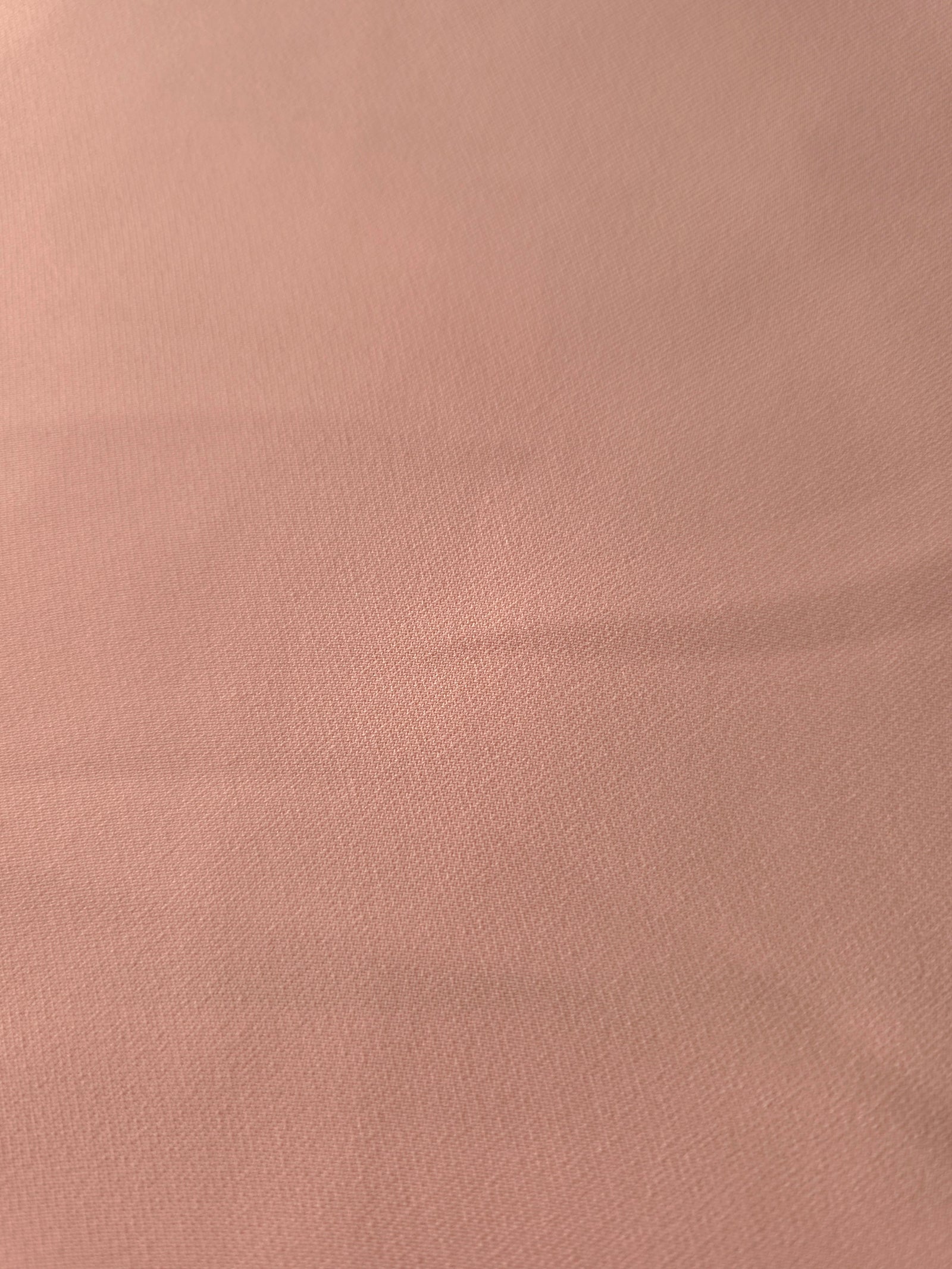 Woven close-up of Rose Beige mechanical polyester crepe showing smooth texture and a soft silky-feel finish