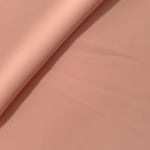 Rose Beige polyester crepe gathered into a soft fold, showing fluid drape for dresses and blouse making