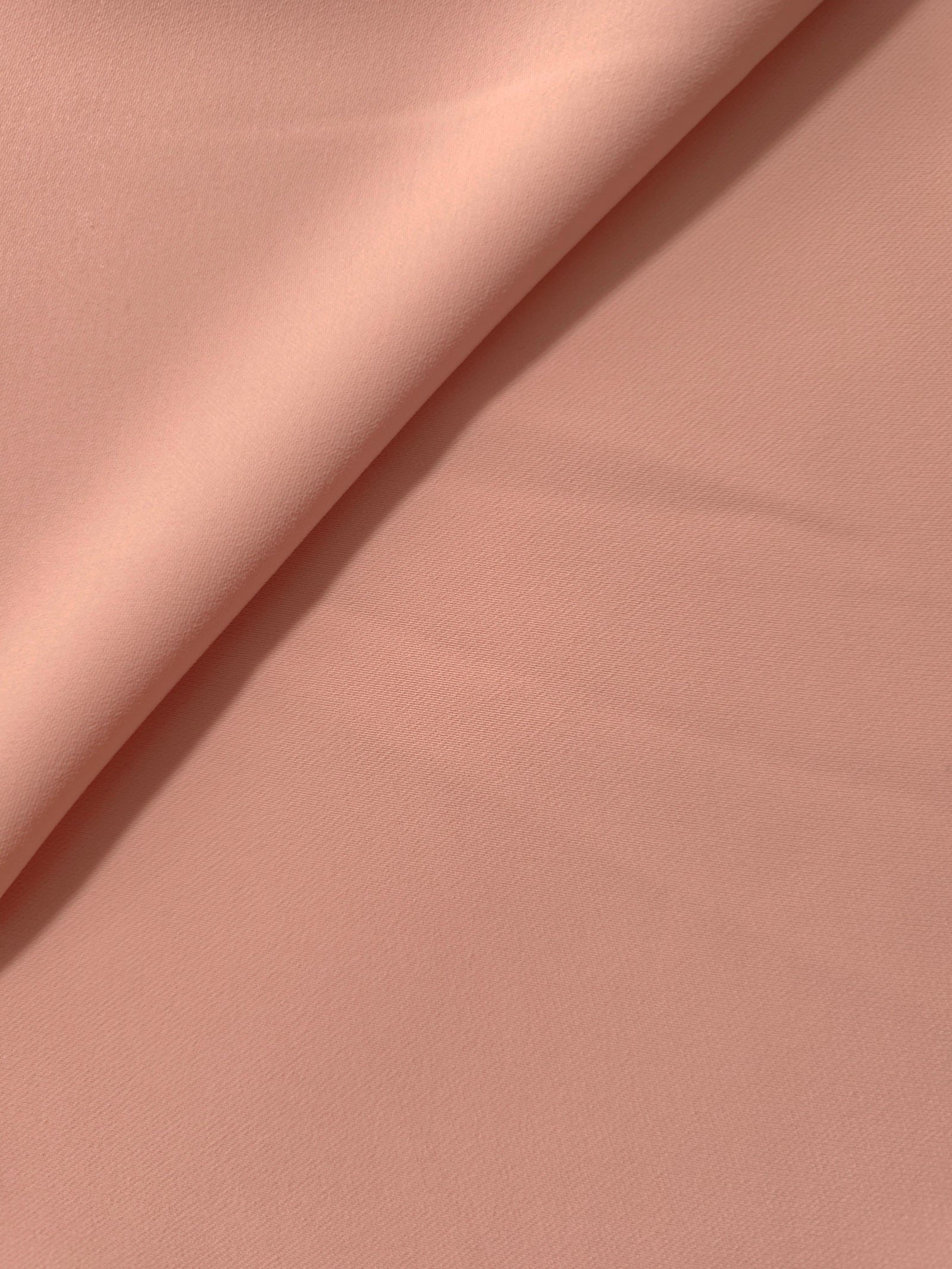 Rose Beige polyester crepe gathered into a soft fold, showing fluid drape for dresses and blouse making