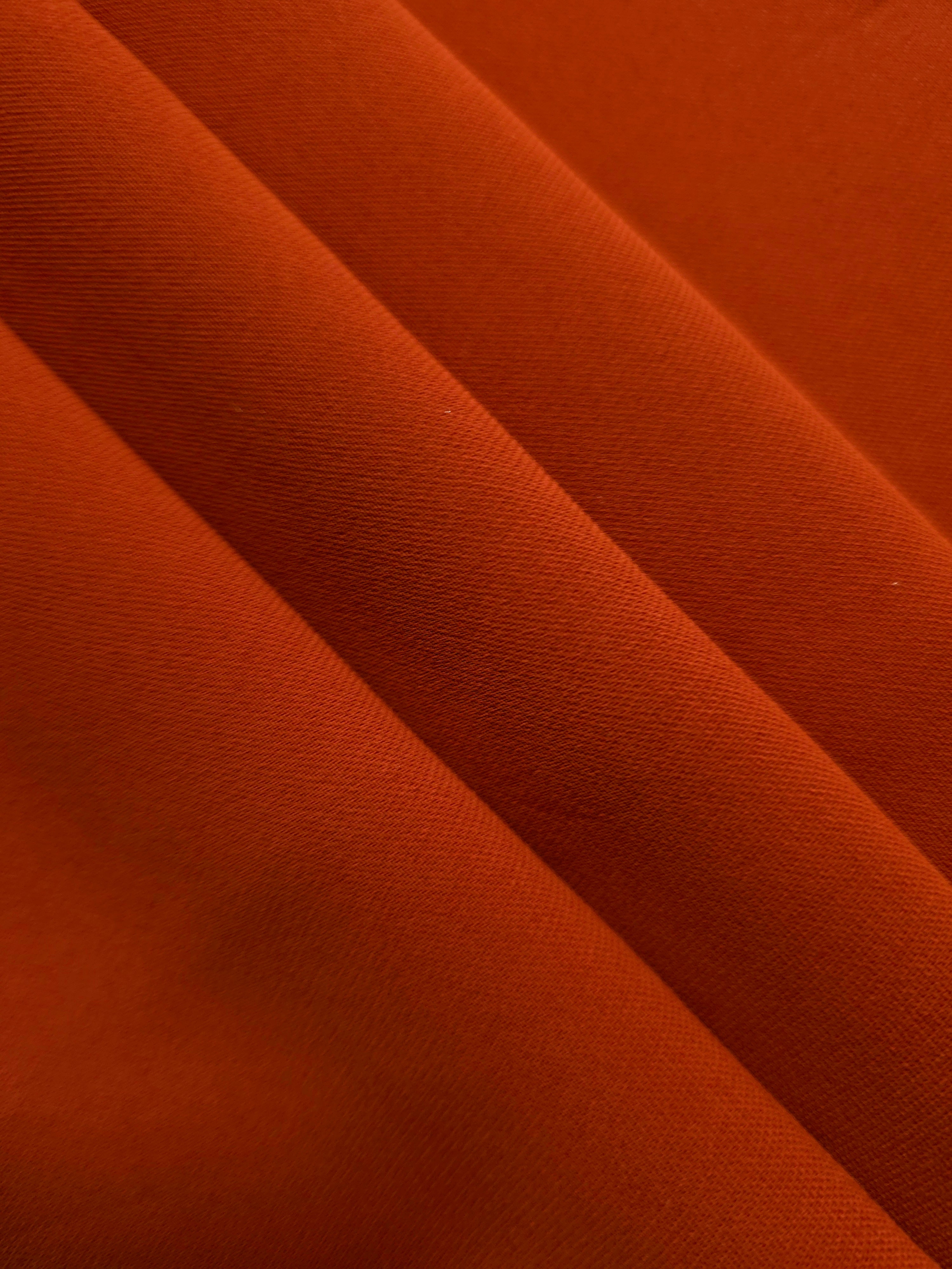 Rust Orange mechanical polyester crepe layered to show soft structure for tailored garments and separates