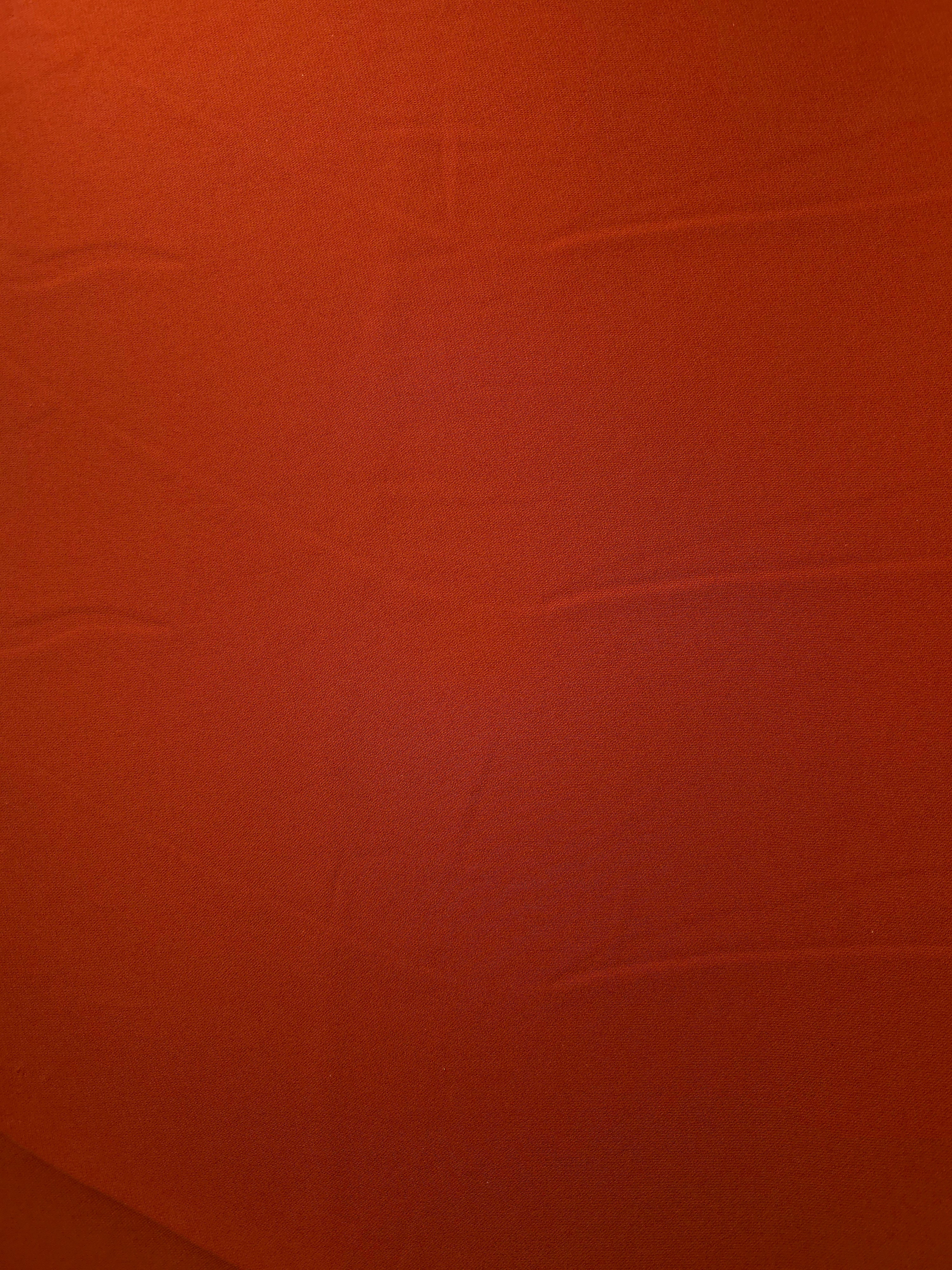 Surface view of Rust Orange 205 GSM polyester crepe, opaque Korean dress fabric with a smooth woven finish