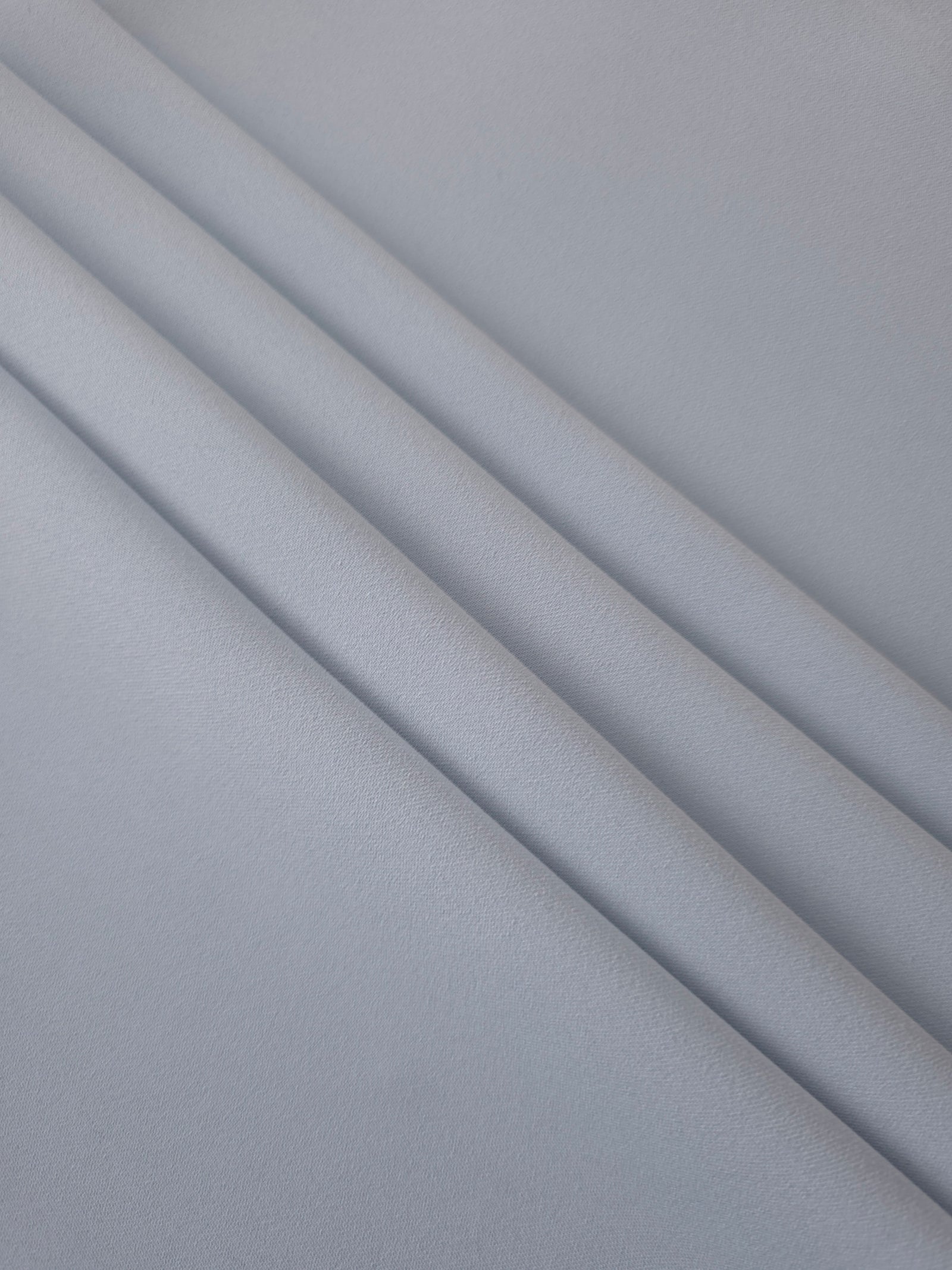 Silver Blue mechanical polyester crepe layered to show soft structure for tailored garments and separates