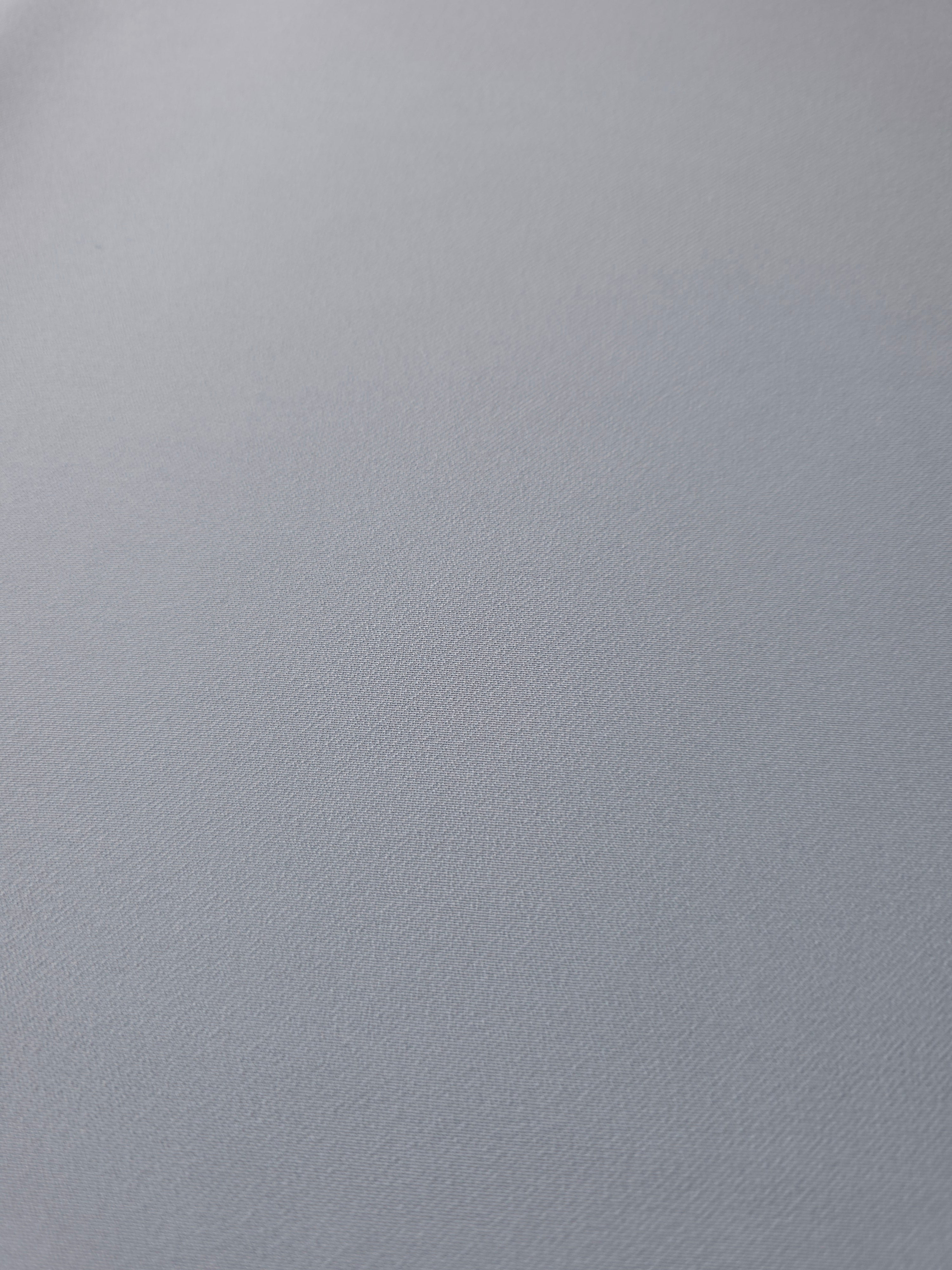 Close woven detail of Silver Blue 100% polyester Korean crepe showing its smooth texture and soft finish
