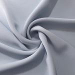 Flowing swirl of Silver Blue Korean polyester crepe showing soft drape for blouses, dresses and abayas