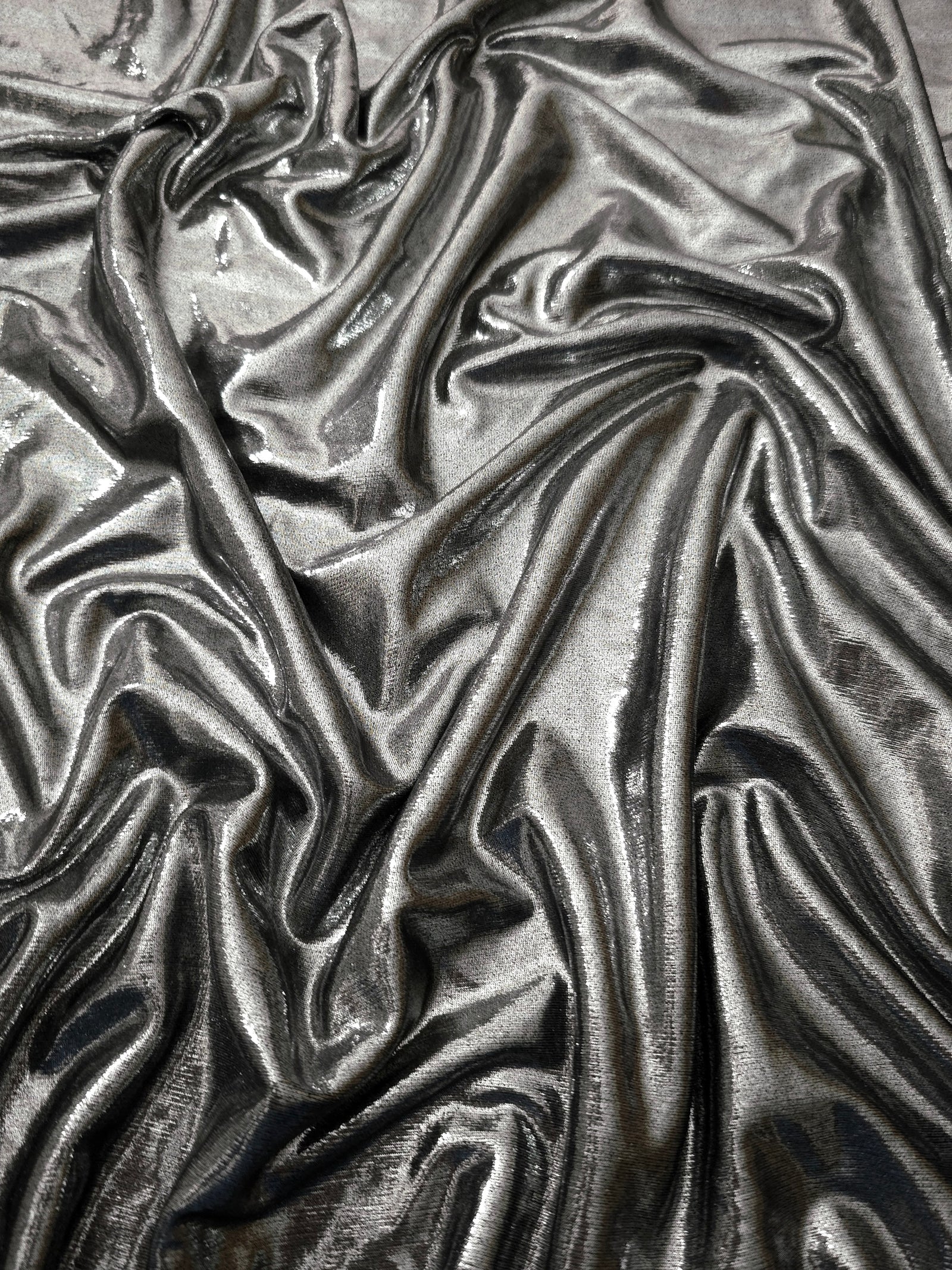 Softly draped Silver Gray foiled spandex fabric showing fluid shape and metallic shimmer for dresses, stage costumes and eventwear