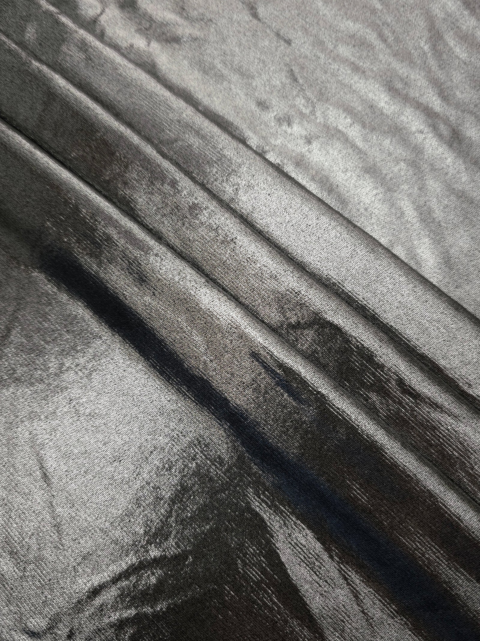 Silver Gray foiled spandex arranged in layered folds, displaying shimmer and soft structure for skirts, tops and performancewear