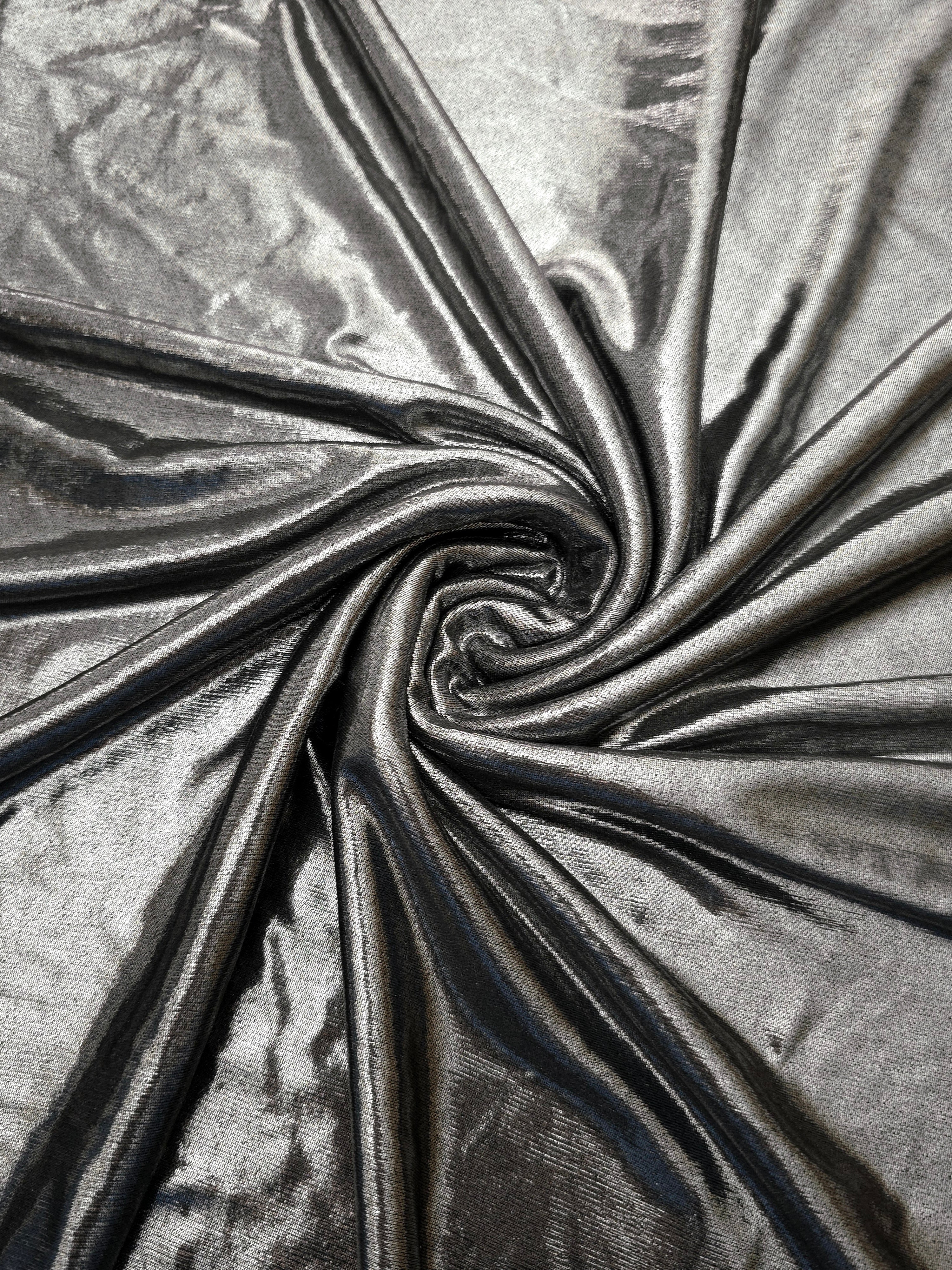 Flowing swirl of Silver Gray metallic stretch fabric, showing dynamic foil reflection for stagewear, skirts and creative fashion