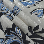 Reverse side of blue sketch floral jacquard fabric showing woven structure and linen-look texture.