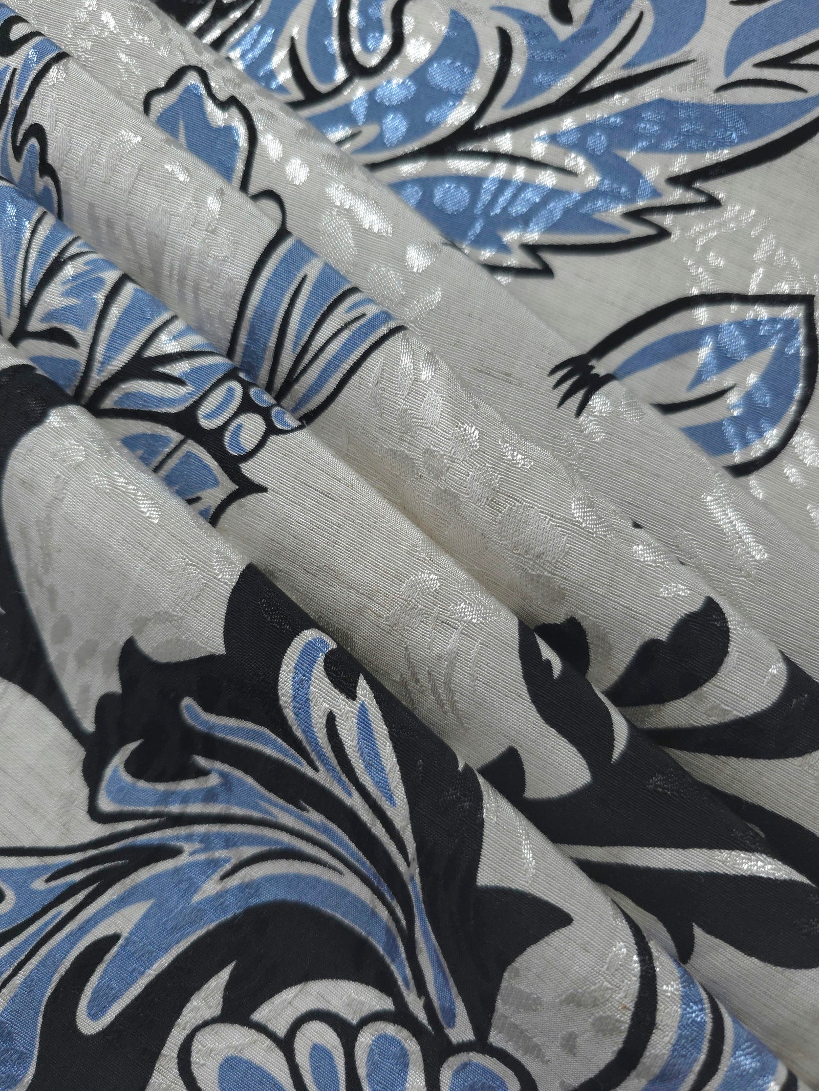 Reverse side of blue sketch floral jacquard fabric showing woven structure and linen-look texture.