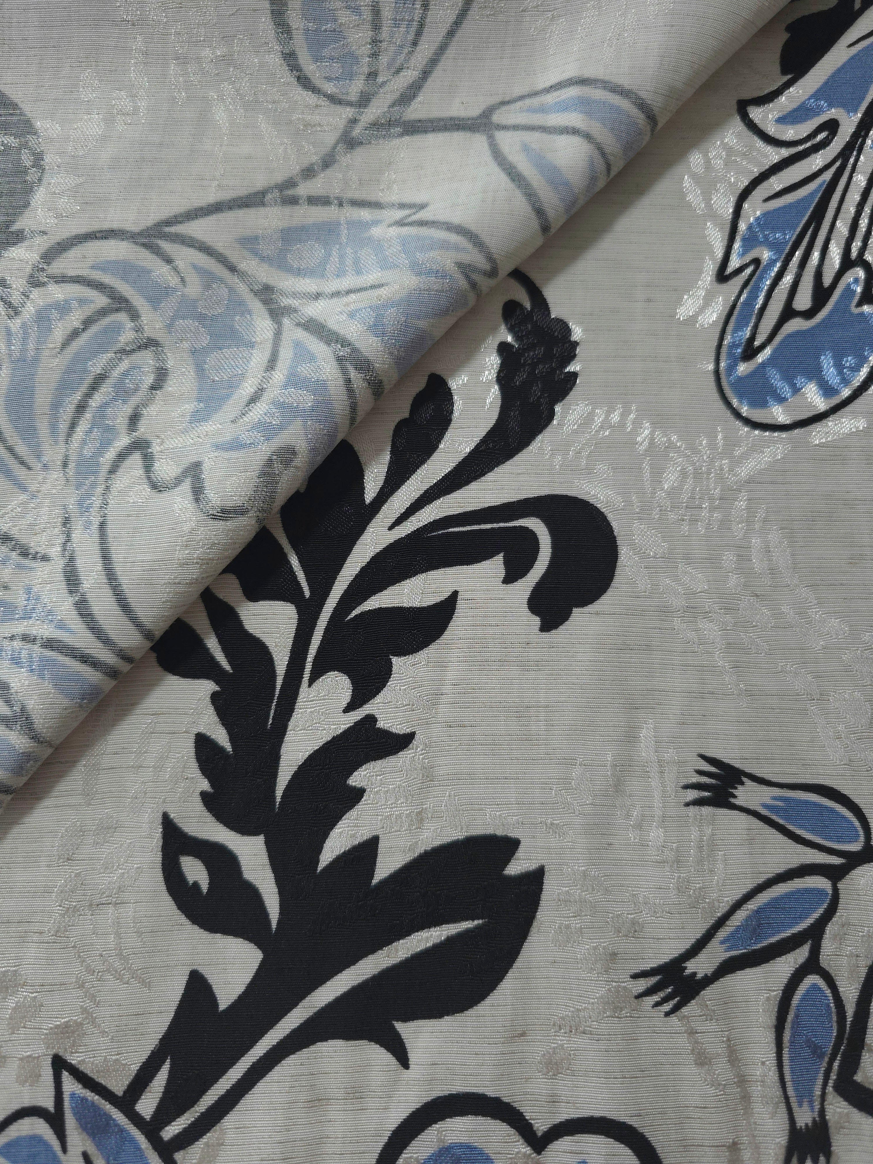 Blue sketch floral jacquard fabric close-up detail showing woven flower texture.