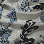 Blue sketch floral linen-look jacquard fabric draped to show soft body and tonal floral pattern.