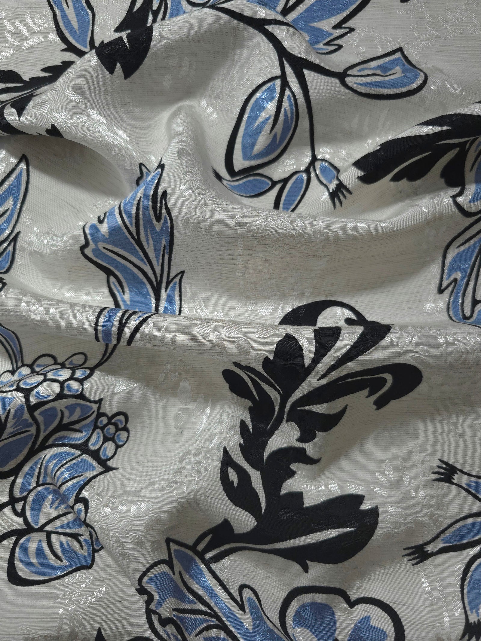 Blue sketch floral linen-look jacquard fabric draped to show soft body and tonal floral pattern.