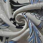 Blue sketch floral linen-look jacquard fabric folded view showing apparel drape and woven texture.