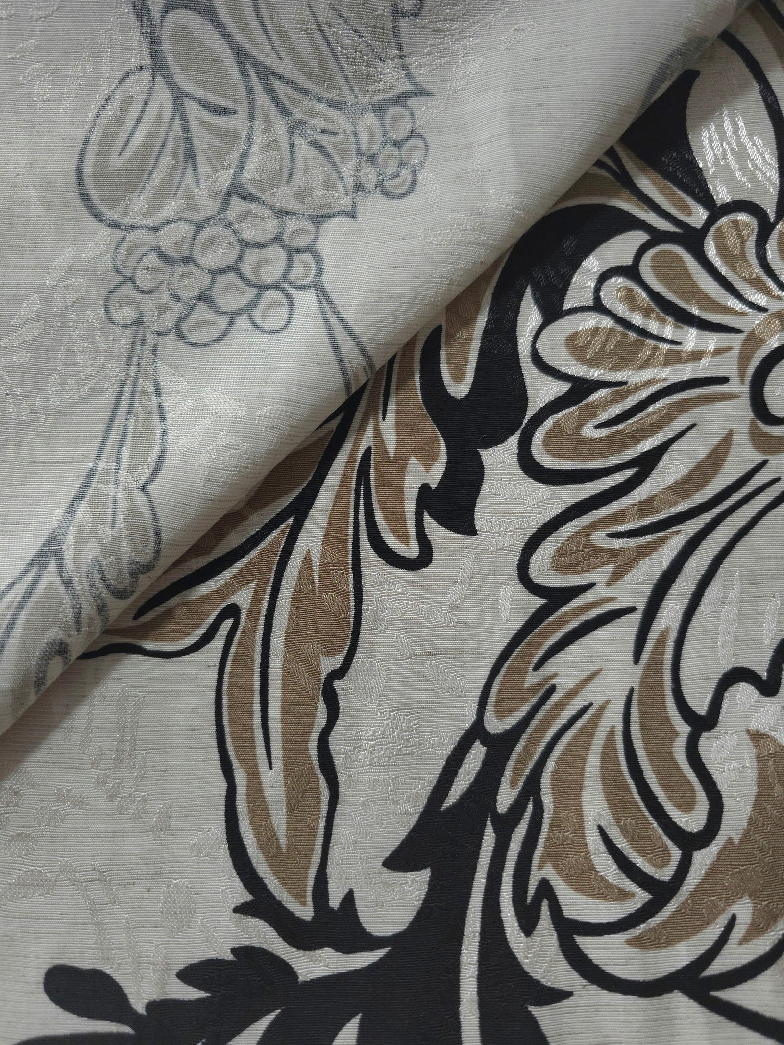 Brown sketch floral jacquard fabric close-up detail showing woven flower texture.