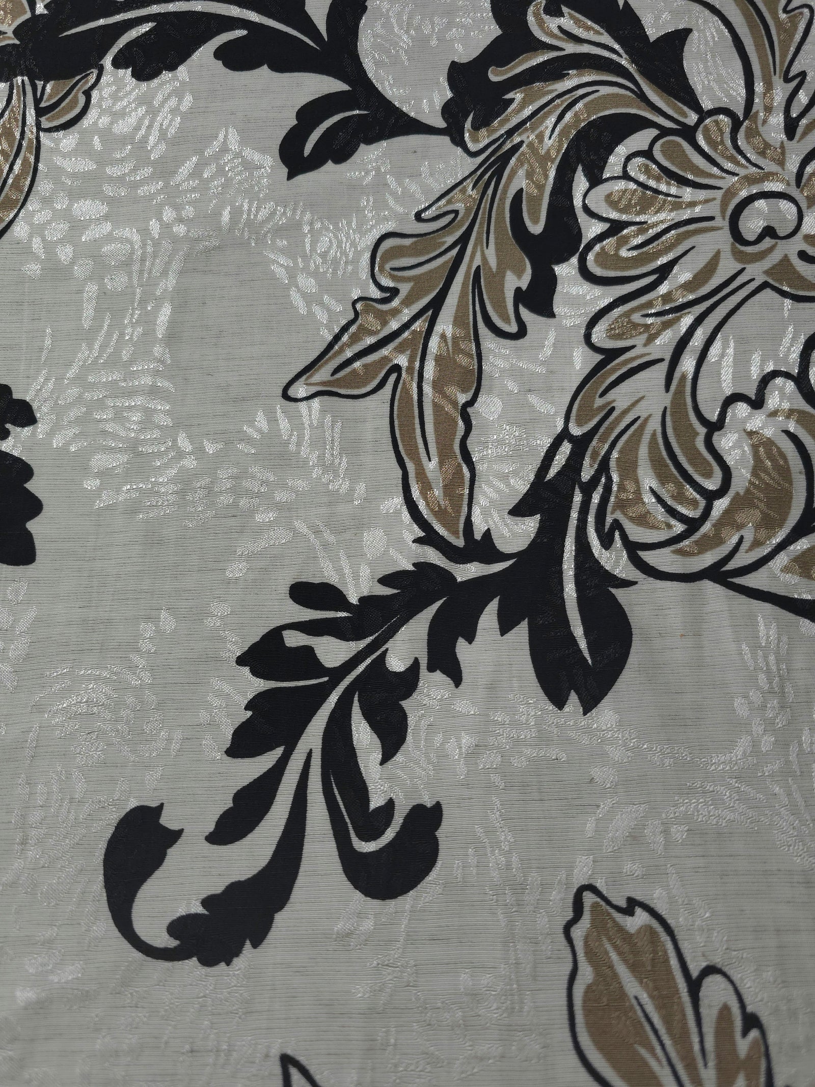 Texture view of brown sketch floral jacquard fabric with woven floral motif.