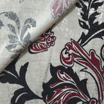 Deep red sketch floral jacquard fabric close-up showing woven flower texture.