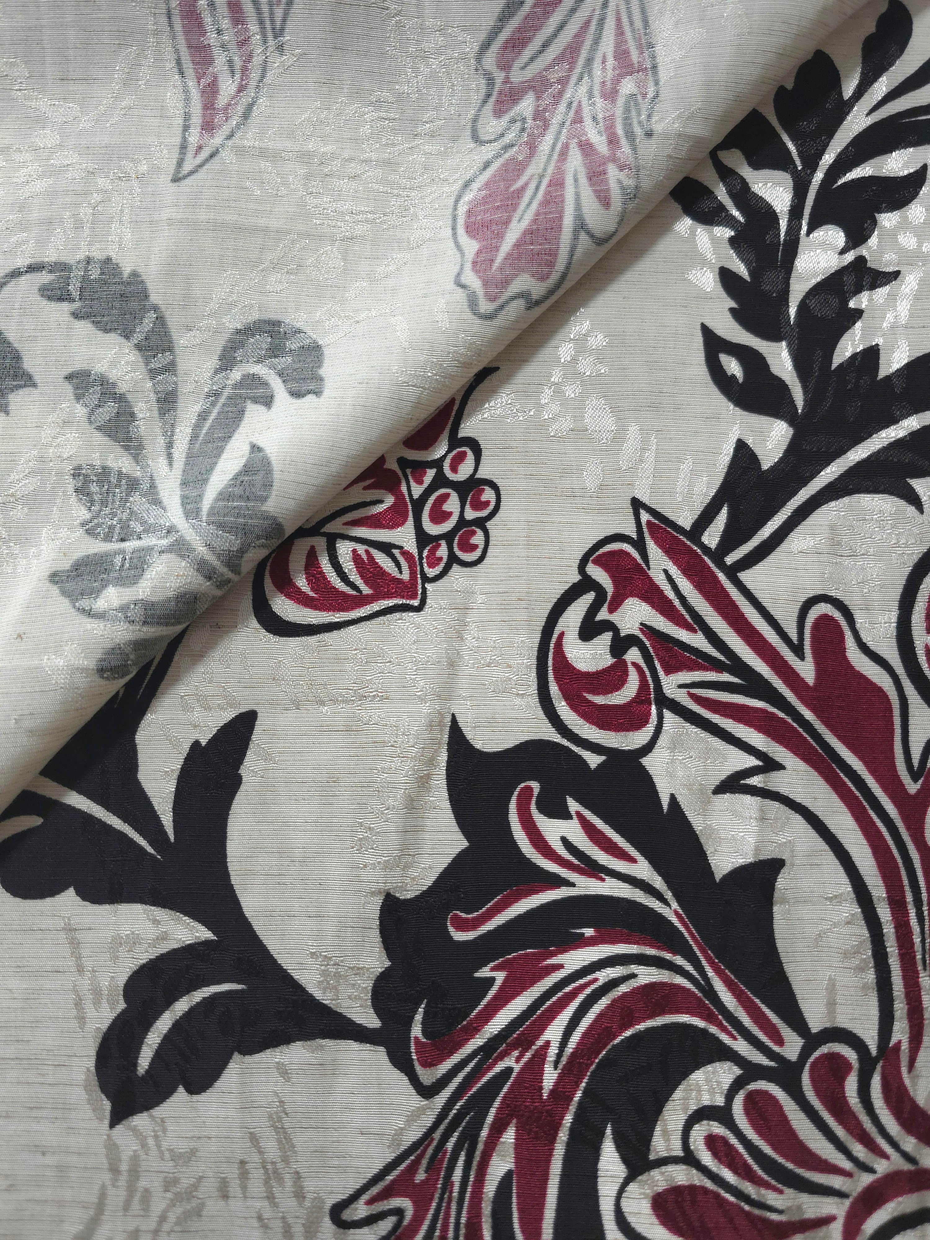 Deep red sketch floral jacquard fabric close-up showing woven flower texture.