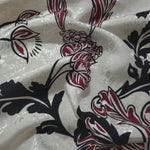 Deep red sketch floral jacquard fabric draped to show apparel movement and woven floral design.