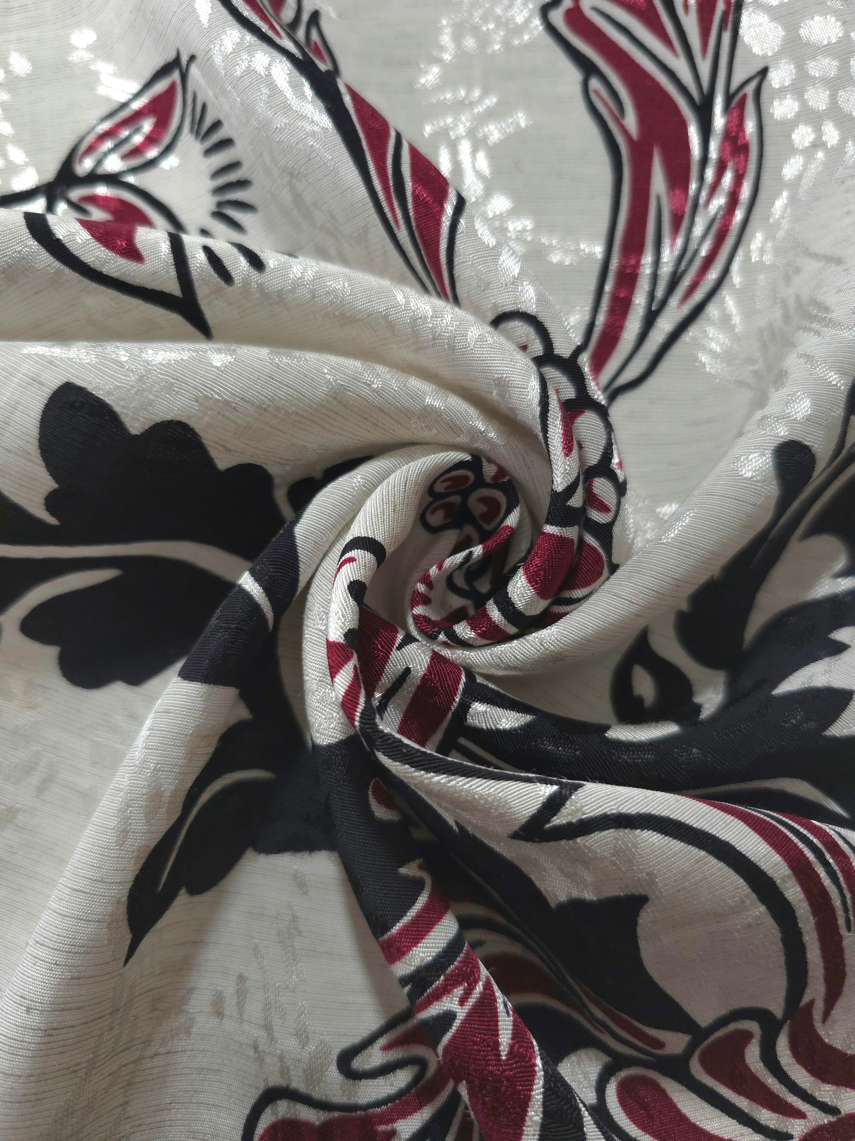 Deep red sketch floral linen-look jacquard fabric folded view showing soft structure and texture.