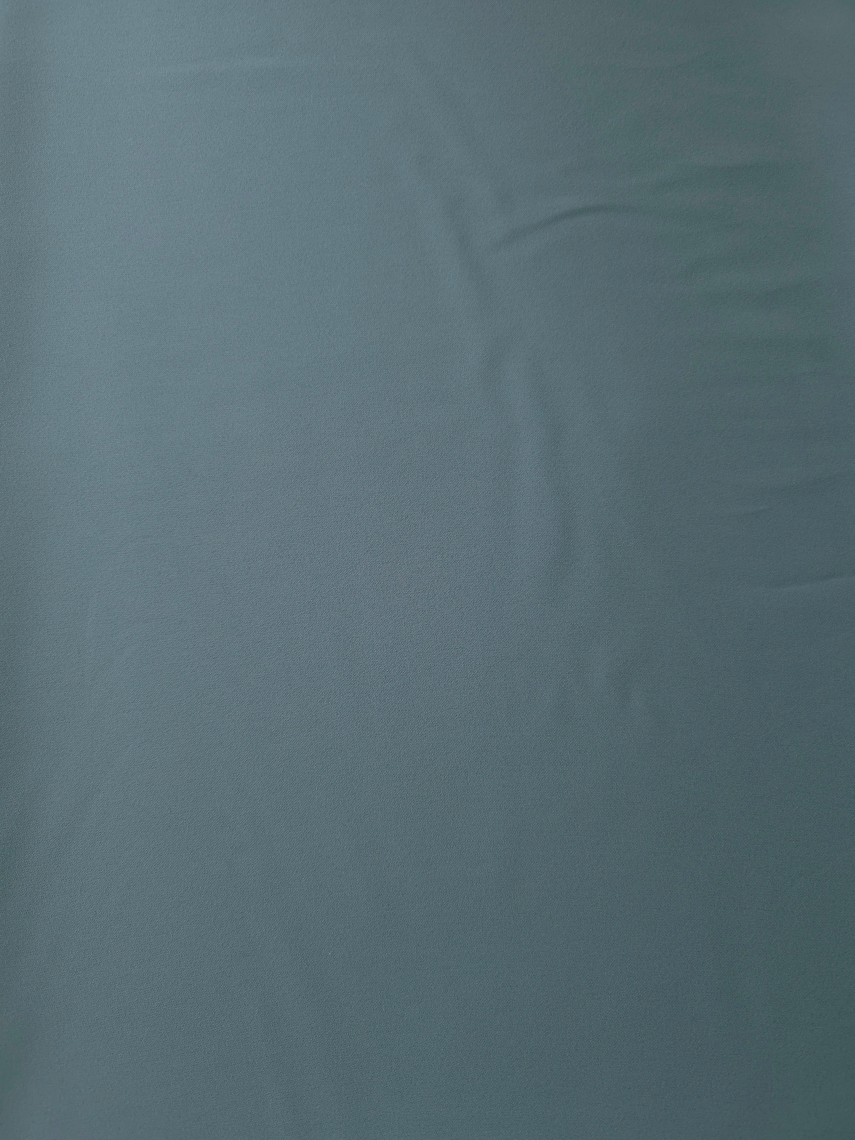 Flat surface of Slate Blue Gray Italian polyester crepe, smooth woven apparel fabric for dresses and separates