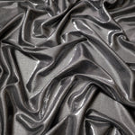 Smoky Gray metallic stretch fabric arranged in elegant folds, showing reflective movement for occasionwear, costumes and fashion design