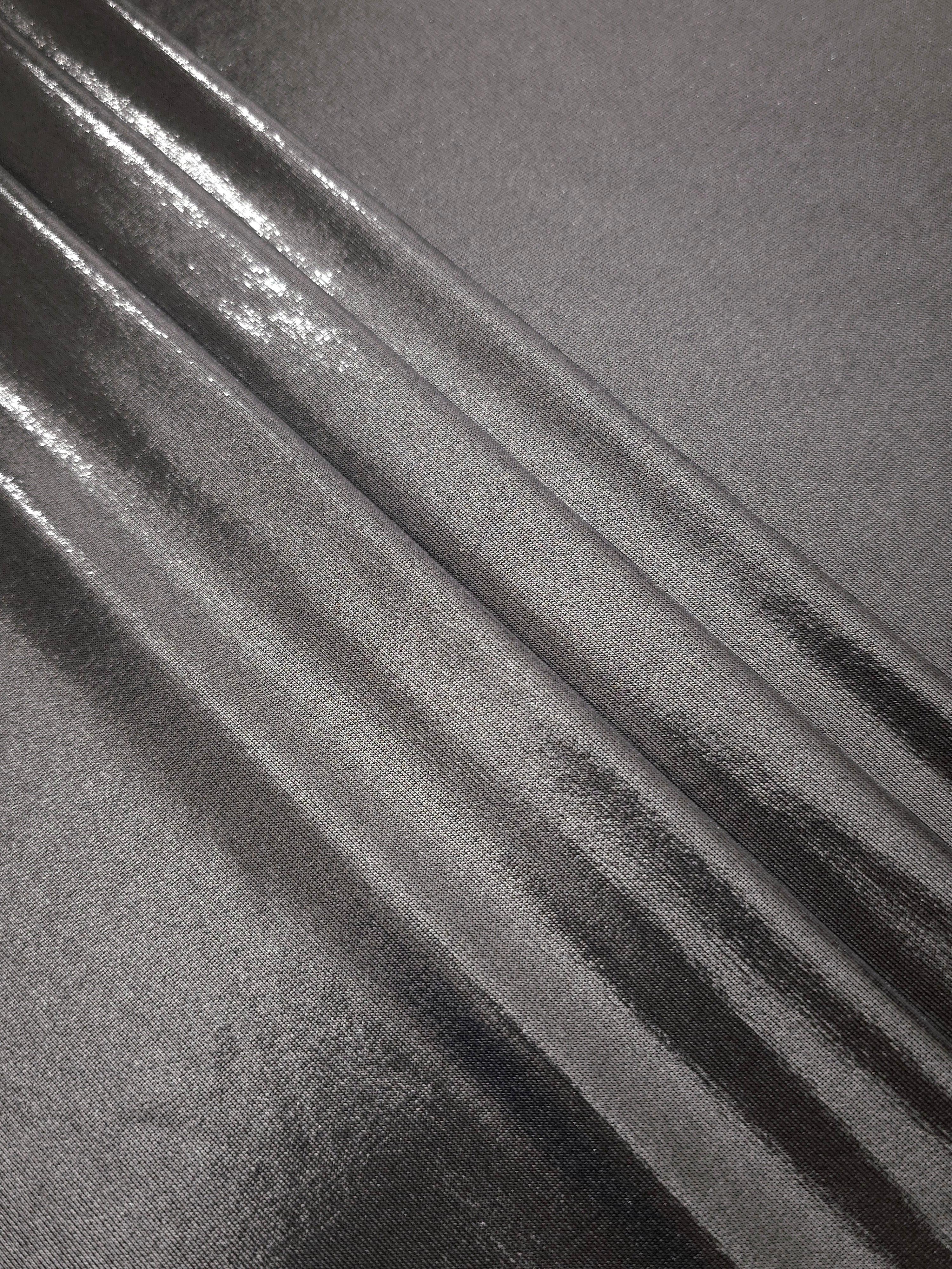 Layered Smoky Gray metallic stretch fabric with reflective foil finish, showing flexible body for dancewear and occasion fashion