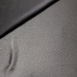 Smoky Gray metallic stretch fabric in a soft fold, revealing reflective drape for dancewear, dresses and statement apparel