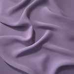 Smoky Lavender Korean polyester dress fabric shown in draped folds for occasionwear, blouses and dresses