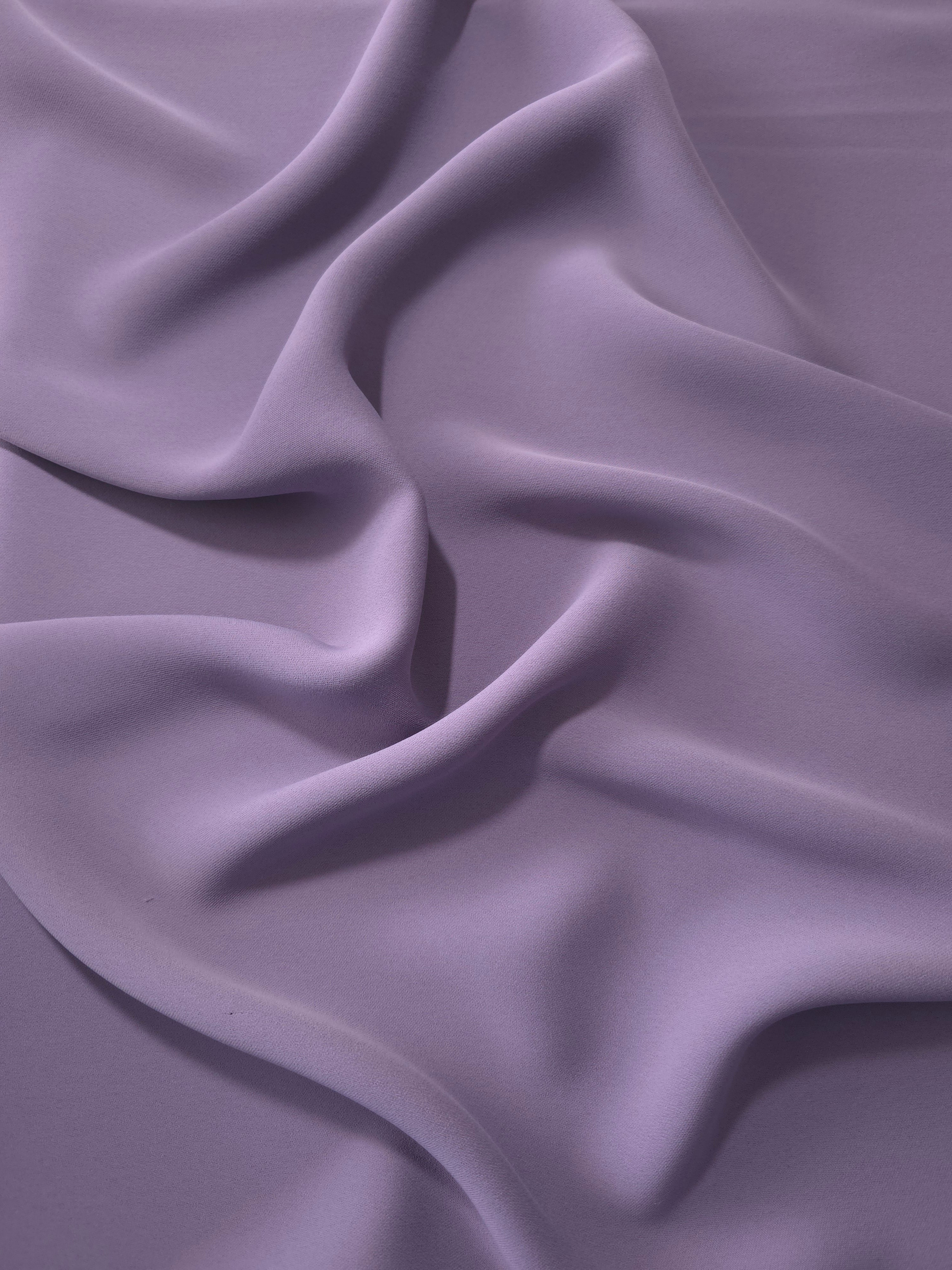 Smoky Lavender Korean polyester dress fabric shown in draped folds for occasionwear, blouses and dresses