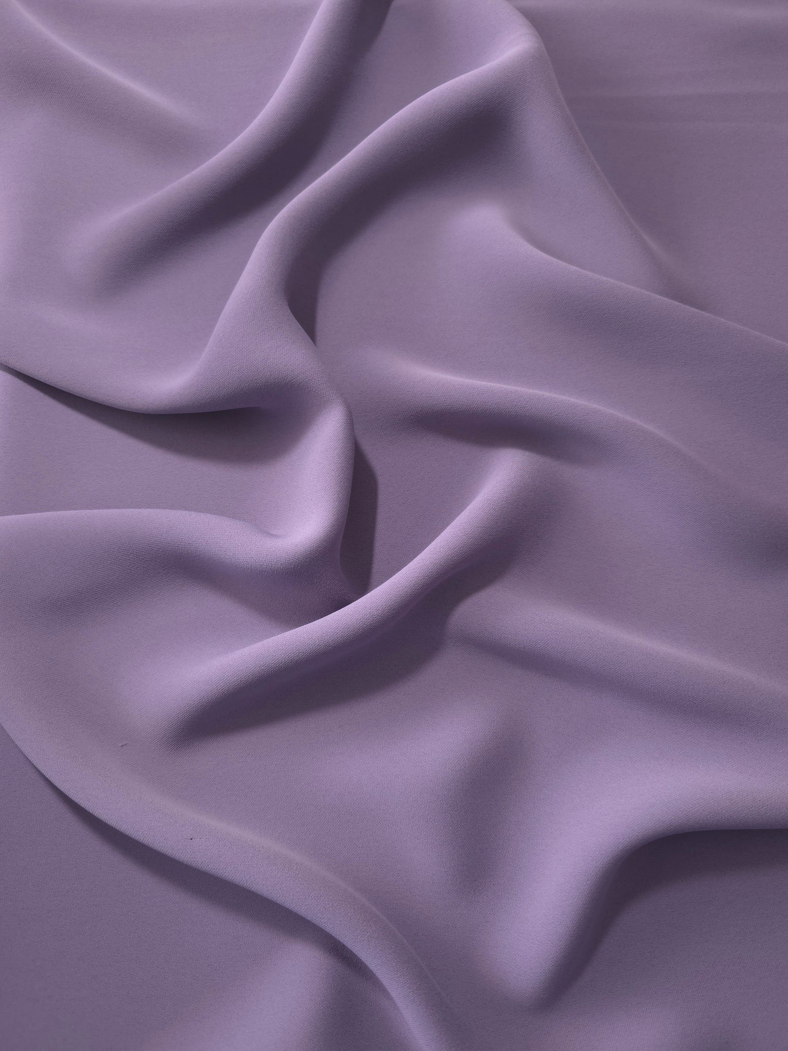 Smoky Lavender Korean polyester dress fabric shown in draped folds for occasionwear, blouses and dresses