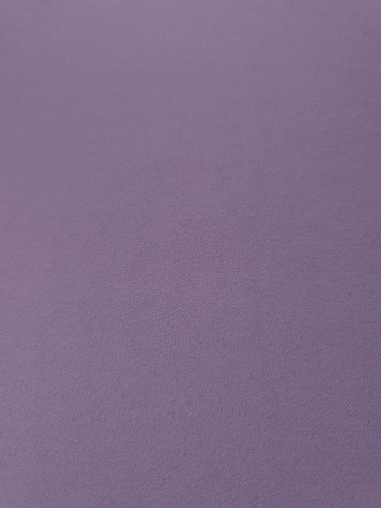 Close woven detail of Smoky Lavender 100% polyester Korean crepe showing its smooth texture and soft finish