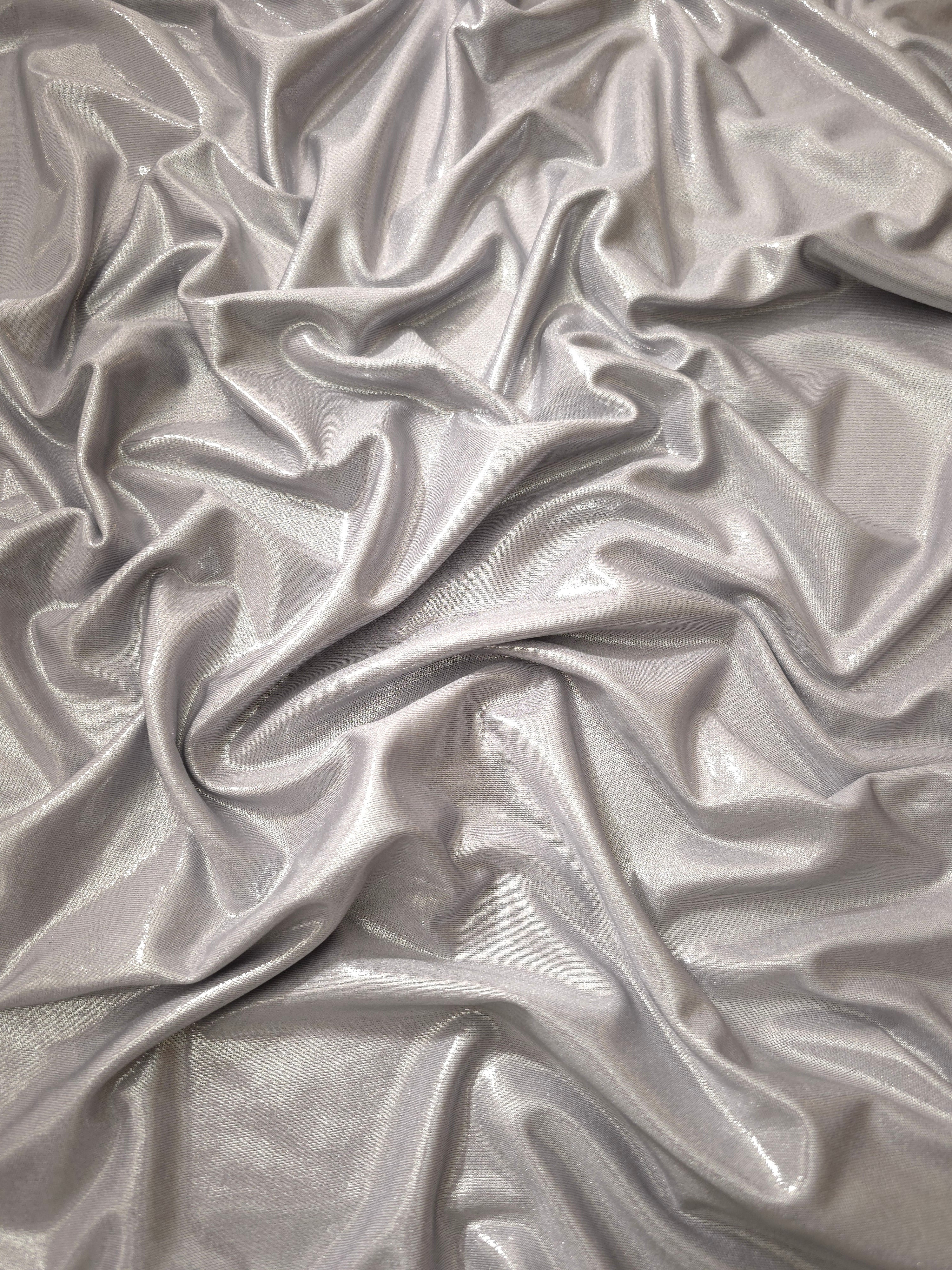 Draped Soft Silver Gray metallic foiled spandex showing reflective folds and flexible flow for dresses, stagewear and occasion looks