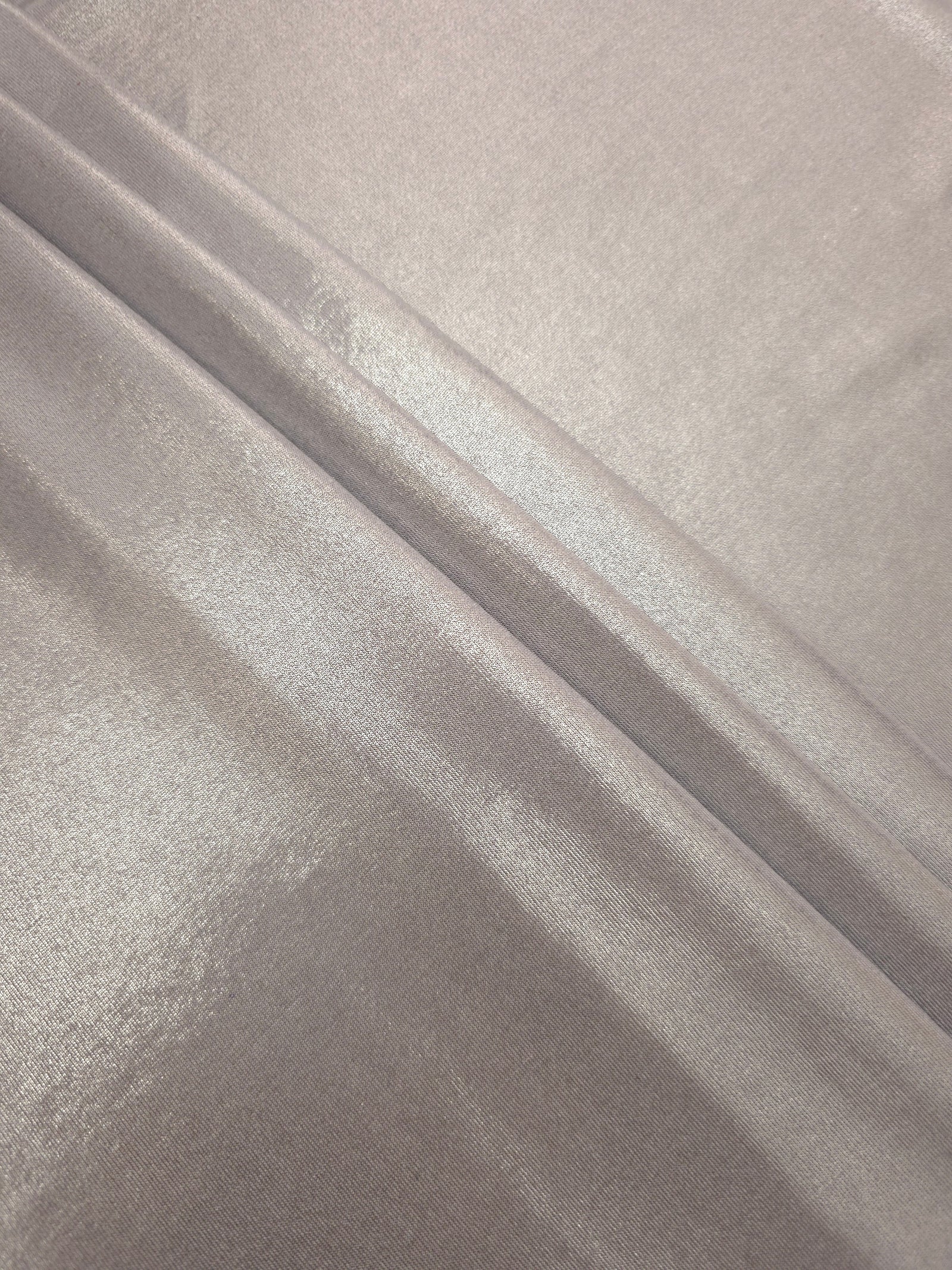 Layered Soft Silver Gray shimmer stretch fabric showing metallic foil depth and soft structure for costumes, skirts and fashion apparel
