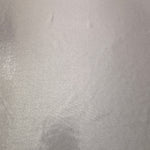 Soft Silver Gray metallic foiled spandex shown flat, reflective stretch fabric for dancewear, eveningwear and statement garments