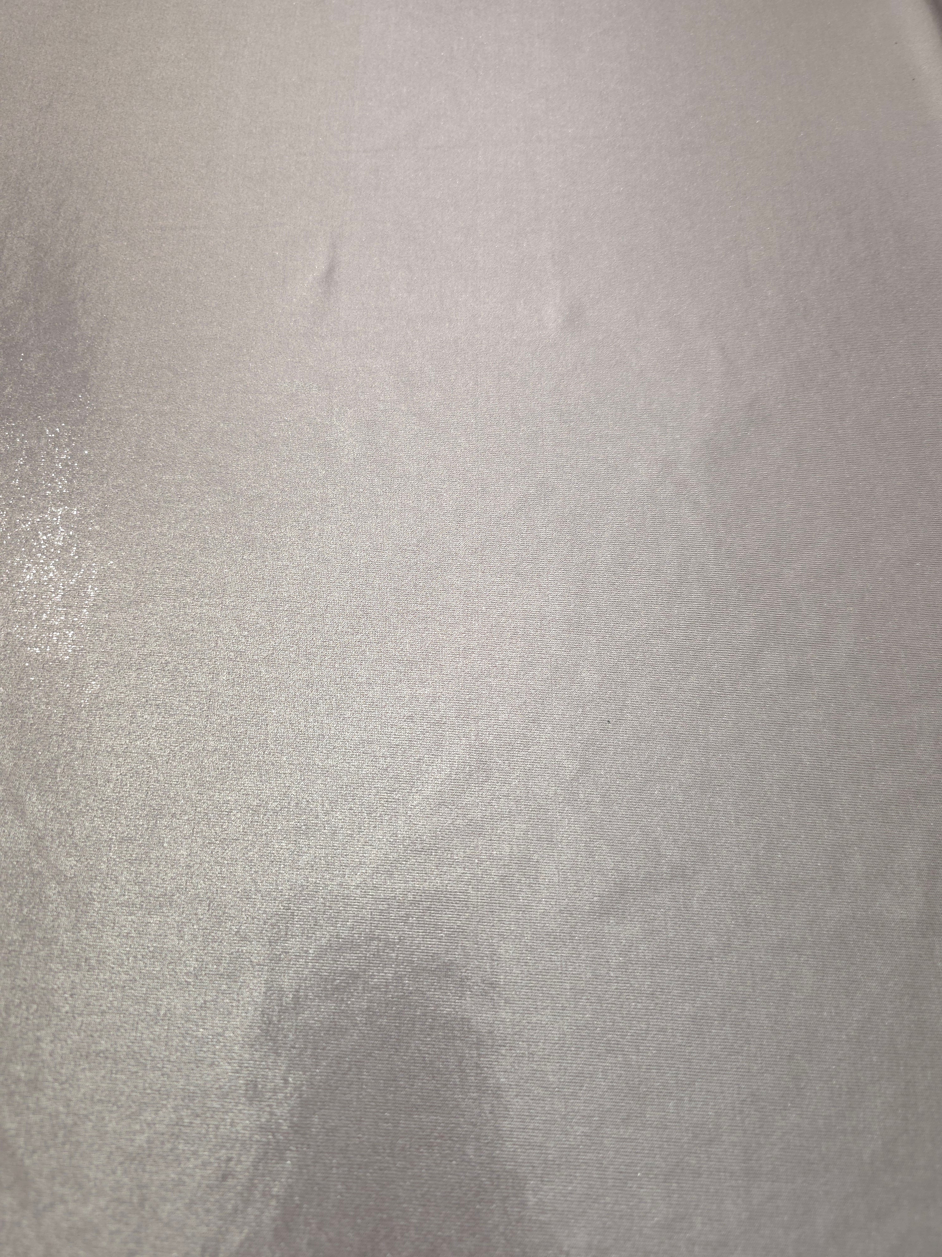 Soft Silver Gray metallic foiled spandex shown flat, reflective stretch fabric for dancewear, eveningwear and statement garments
