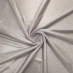 Soft Silver Gray shimmer foiled stretch fabric arranged in a swirl, highlighting movement and reflective finish for performancewear