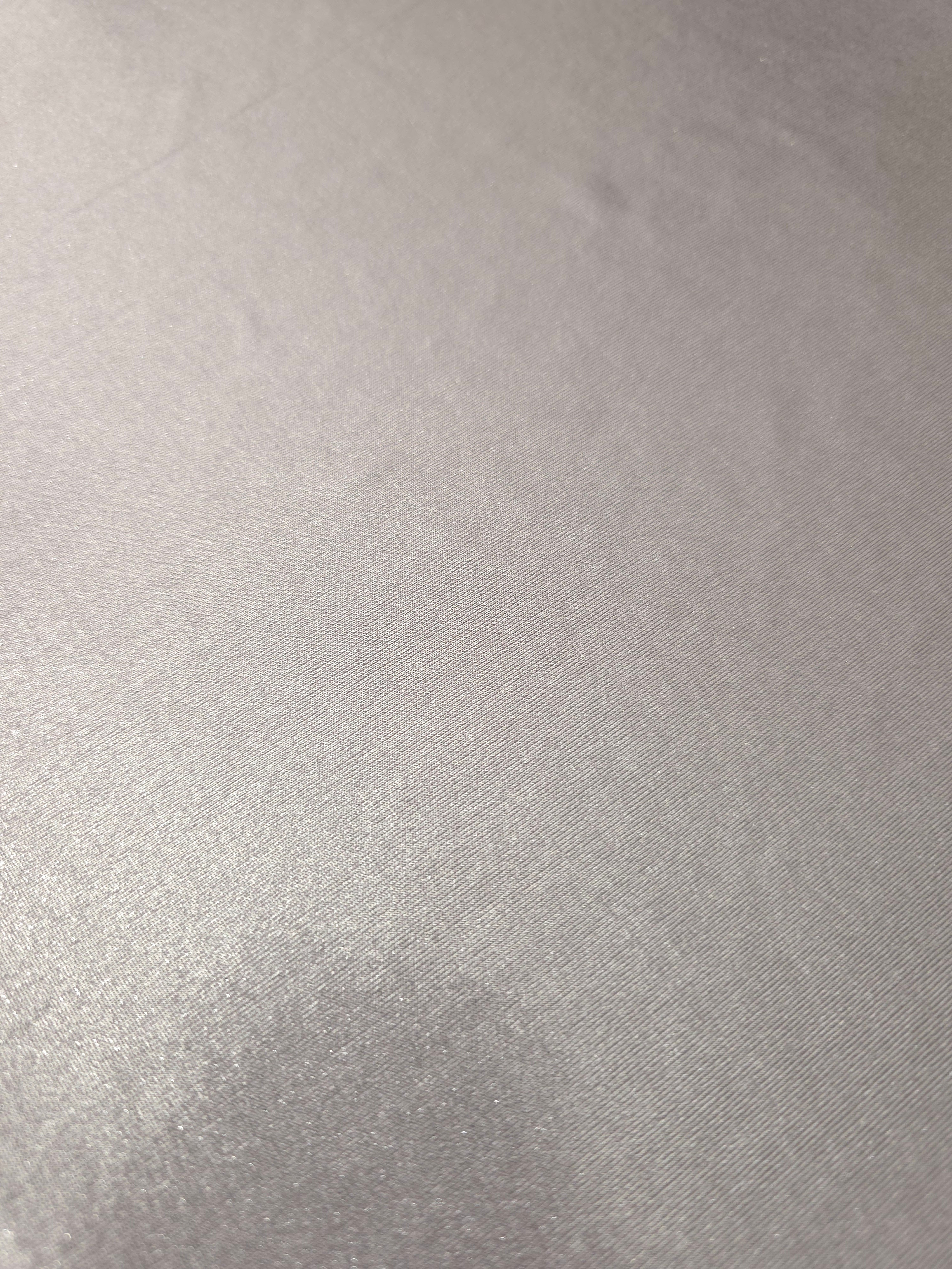 Close-up of Soft Silver Gray metallic foiled spandex showing reflective surface texture and the detailed shimmer finish