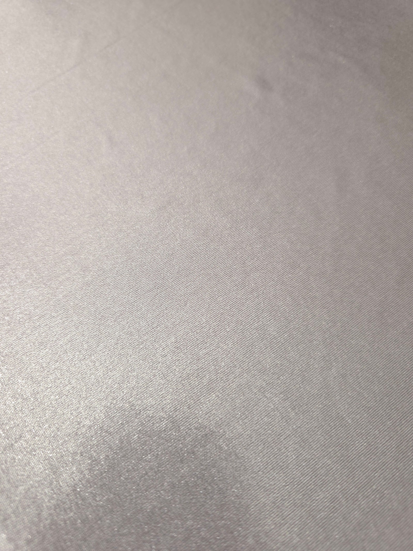 Close-up of Soft Silver Gray metallic foiled spandex showing reflective surface texture and the detailed shimmer finish
