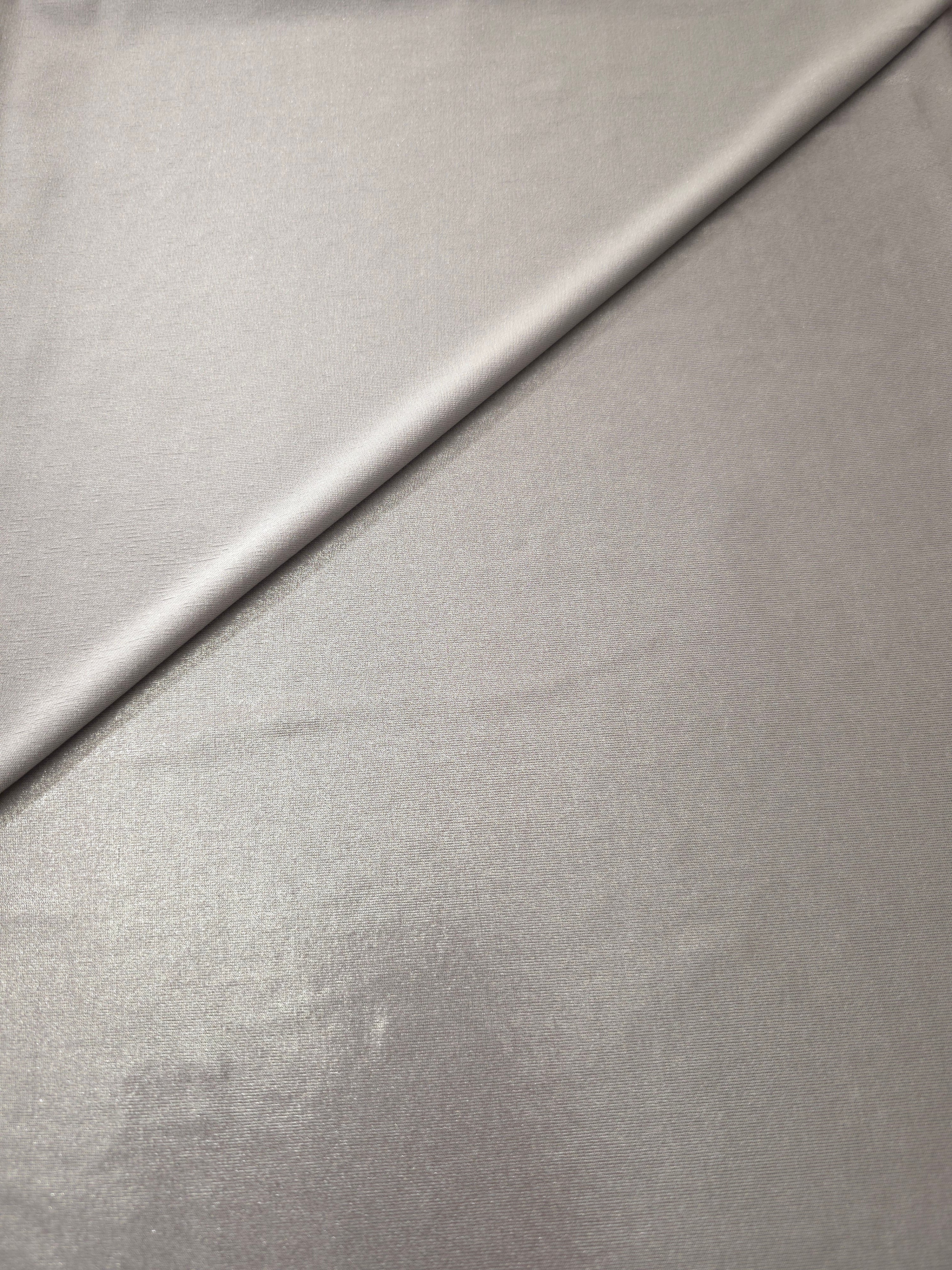 Soft Silver Gray shimmer spandex in a soft fold, showing metallic foil sheen and flexible drape for tops, skirts and costumes