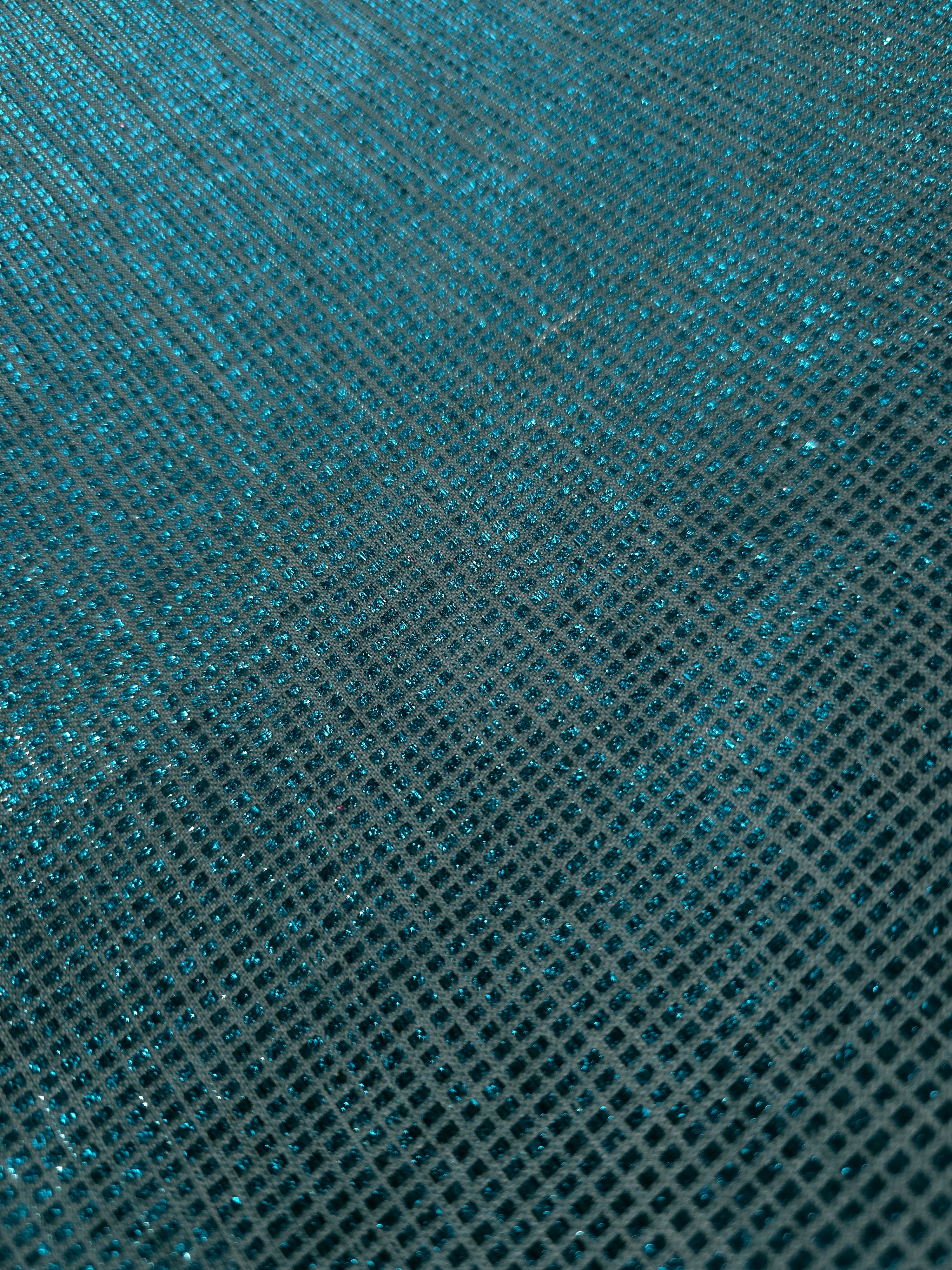 Close-up of Aqua Teal Sheer Square Shimmer Stretch Tulle Fabric revealing the square shimmer repeat and fine transparent mesh