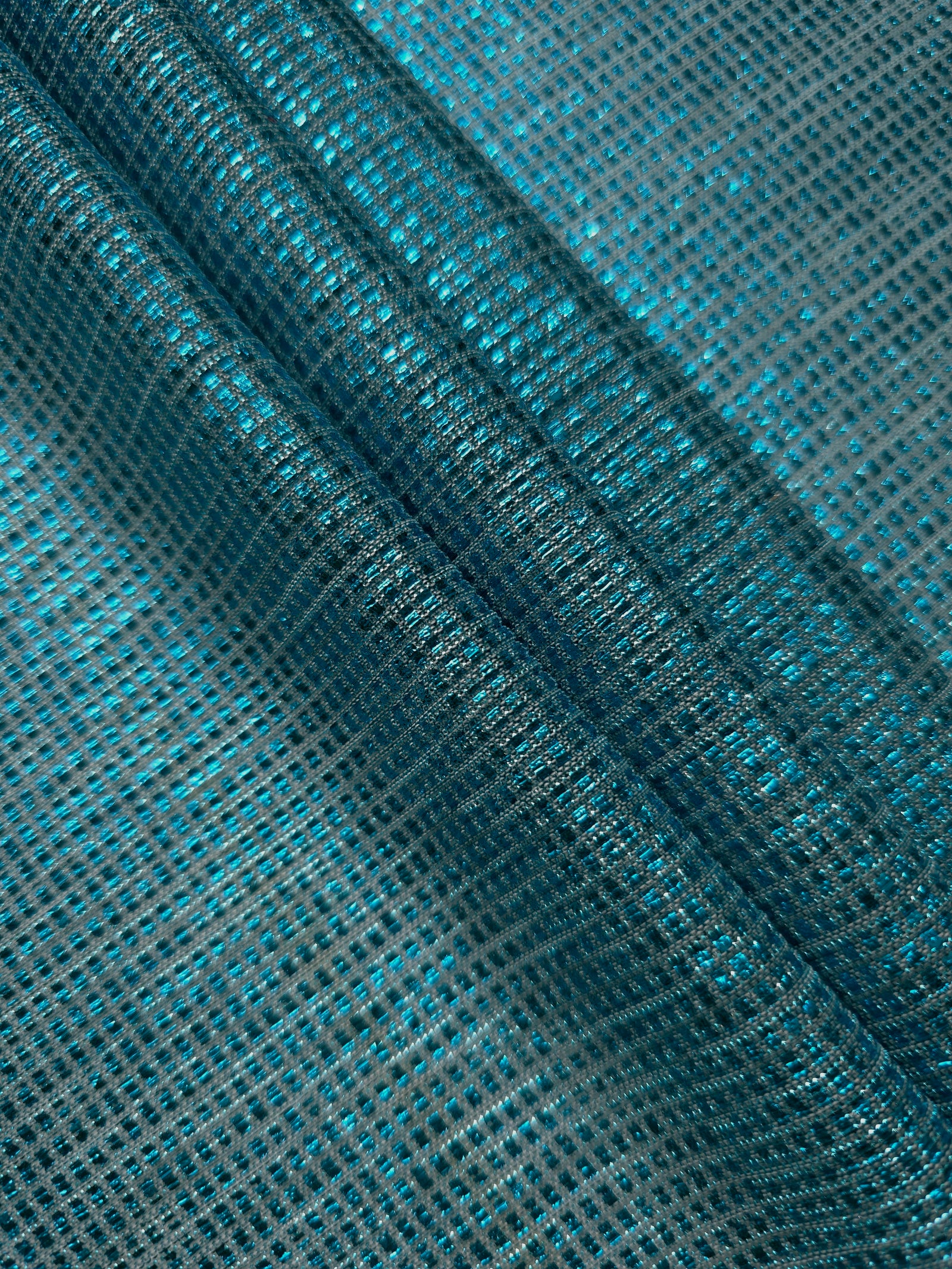 Layered Aqua Teal Sheer Square Shimmer Stretch Tulle Fabric showing overlapping geometry, denser shimmer and translucent depth