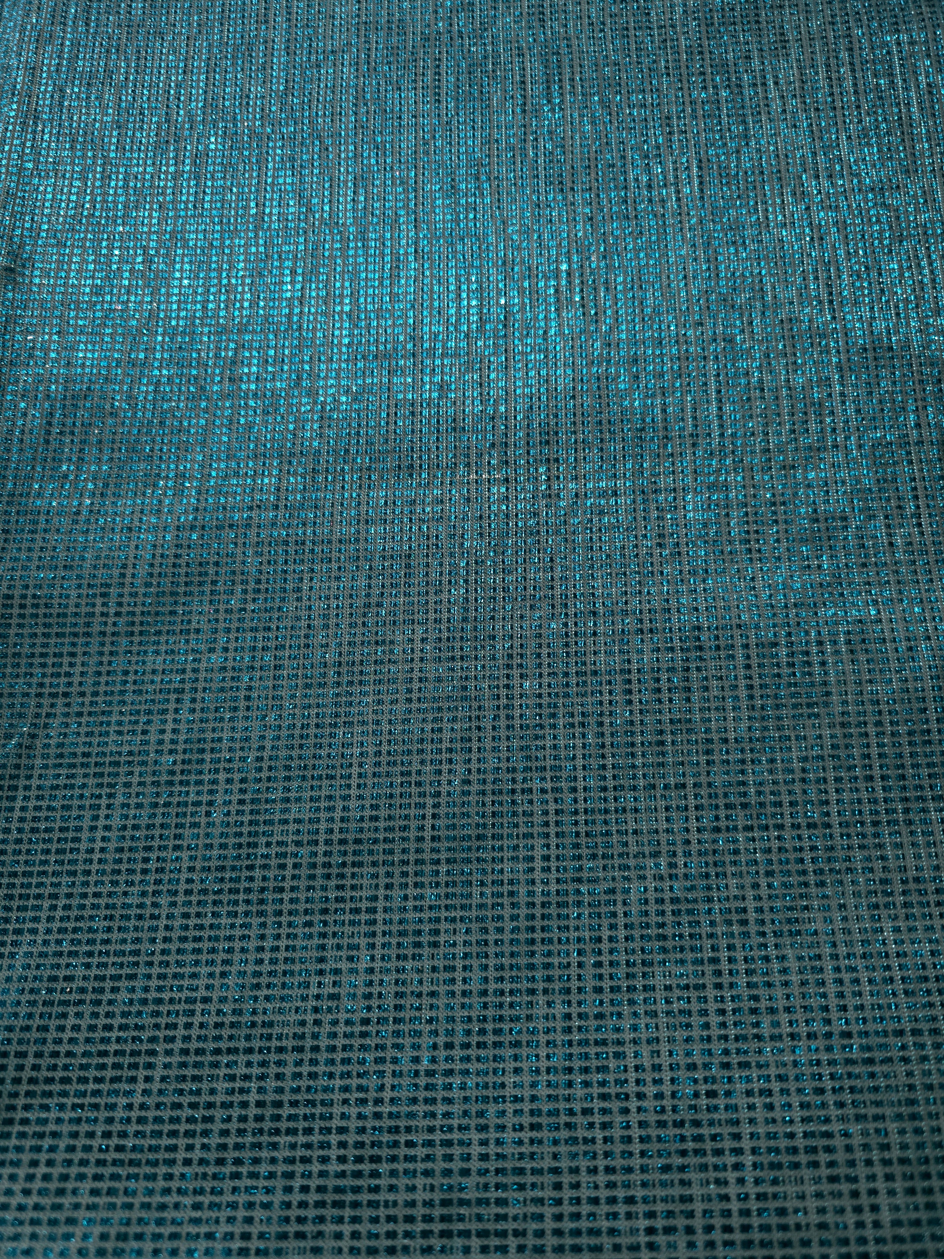 Surface detail of Aqua Teal Sheer Square Shimmer Stretch Tulle Fabric highlighting square grid scale and lightweight tulle texture