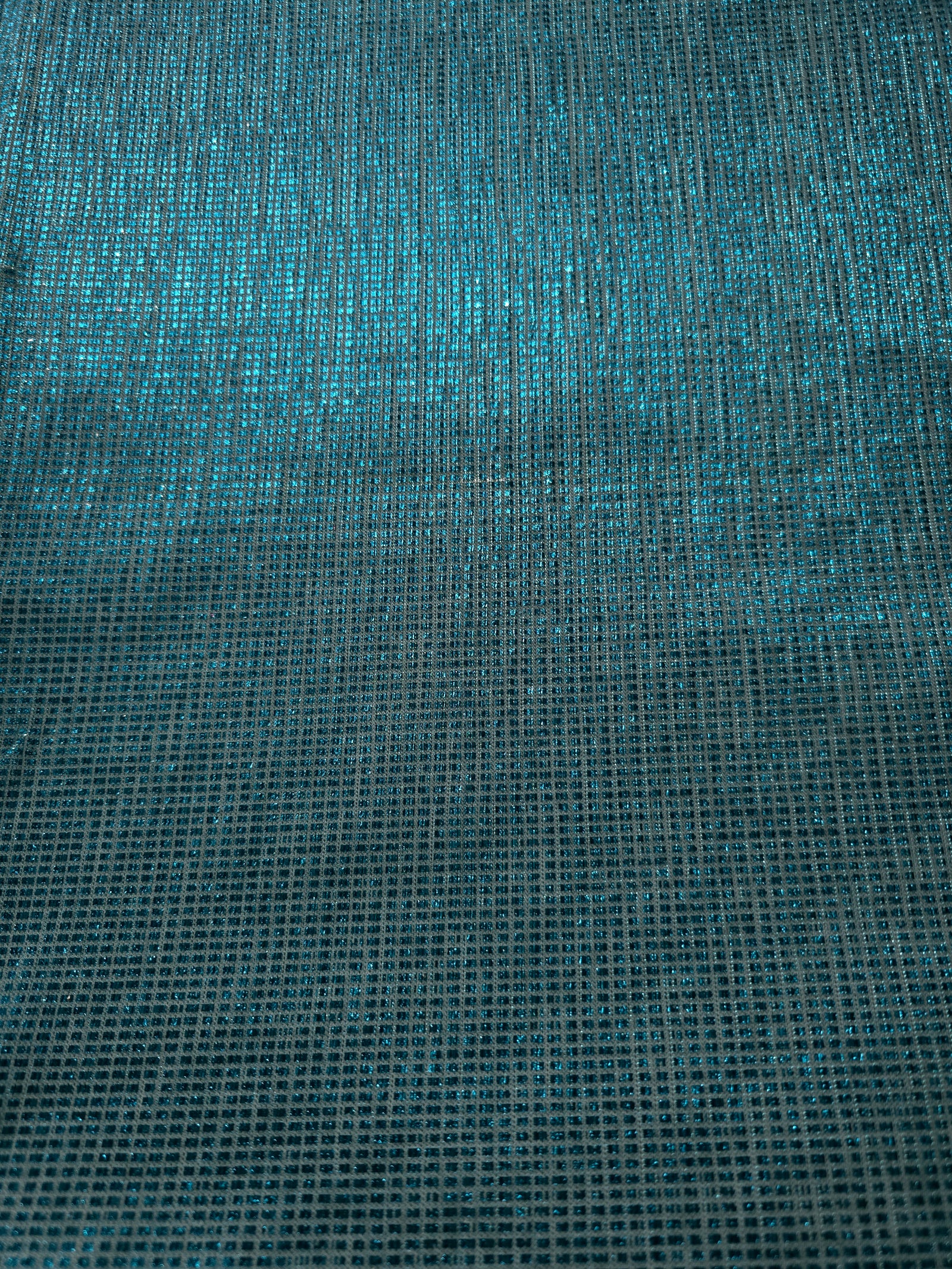Surface detail of Aqua Teal Sheer Square Shimmer Stretch Tulle Fabric highlighting square grid scale and lightweight tulle texture