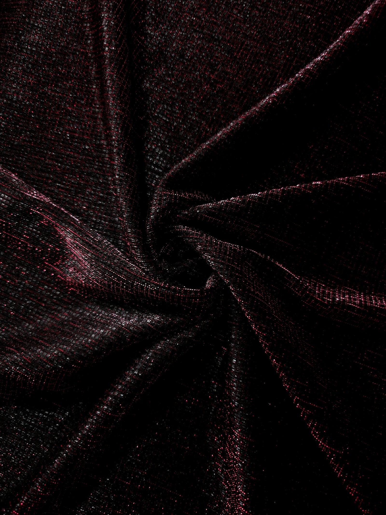 Swirl-draped Black Cherry Sheer Square Shimmer Stretch Tulle Fabric showing structured square reflections moving through soft folds