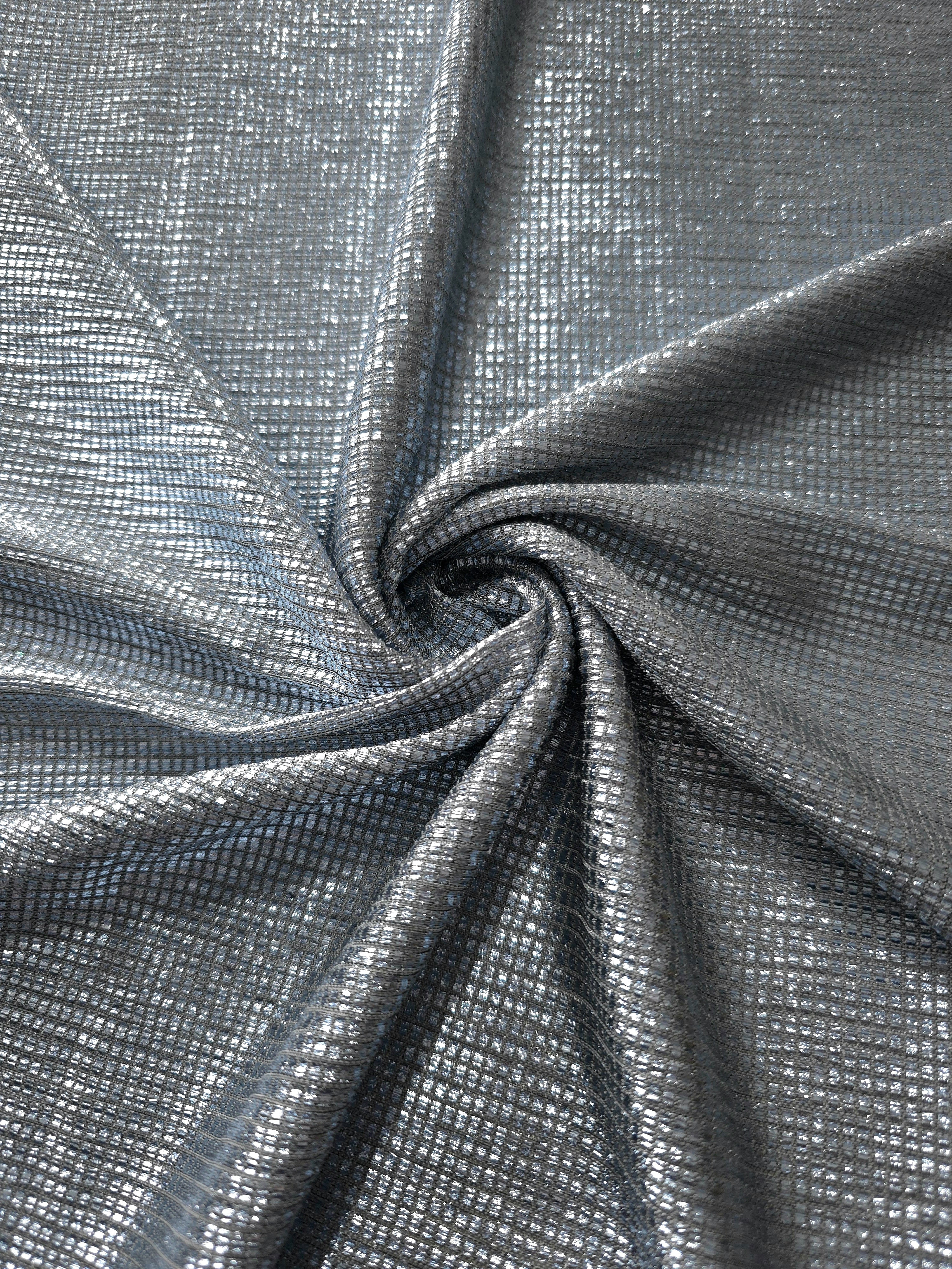 Swirl-draped Bright Silver Sheer Square Shimmer Stretch Tulle Fabric showing structured square reflections moving through soft folds
