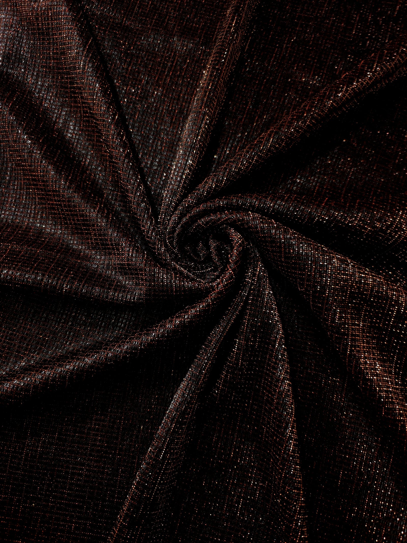 Swirl-draped Burnt Copper Sheer Square Shimmer Stretch Tulle Fabric showing structured square reflections moving through soft folds