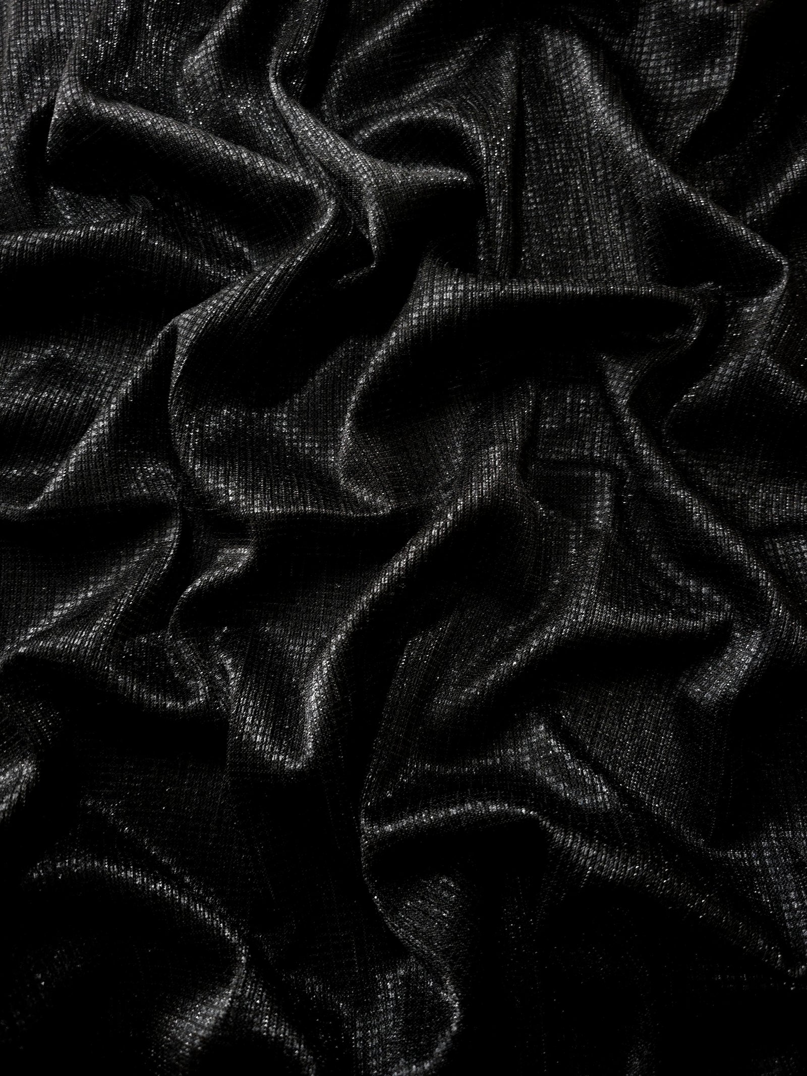 Draped Charcoal Silver Sheer Square Shimmer Stretch Tulle Fabric showing a geometric reflective grid across fluid folds