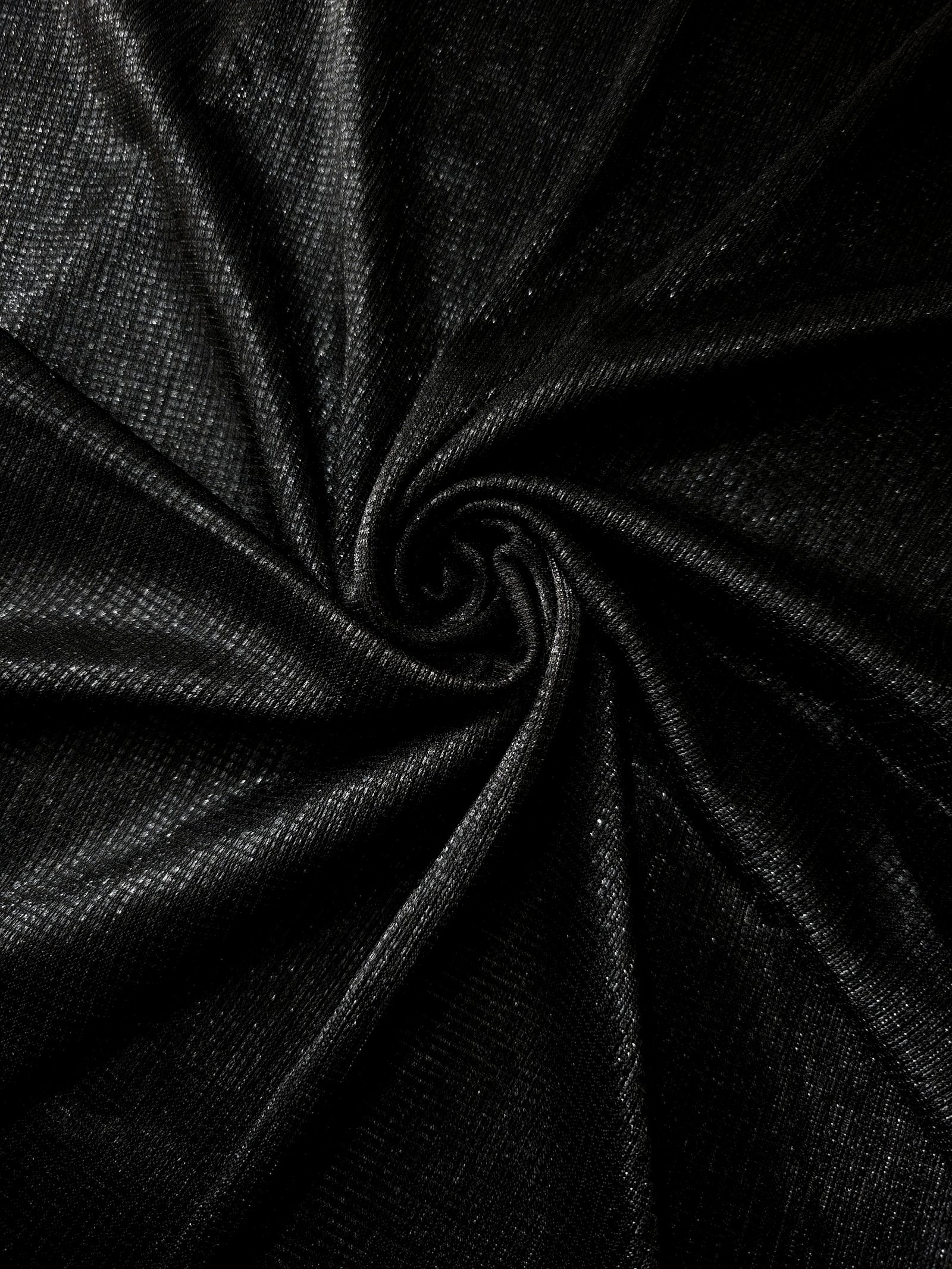 Swirl-draped Charcoal Silver Sheer Square Shimmer Stretch Tulle Fabric showing structured square reflections moving through soft folds